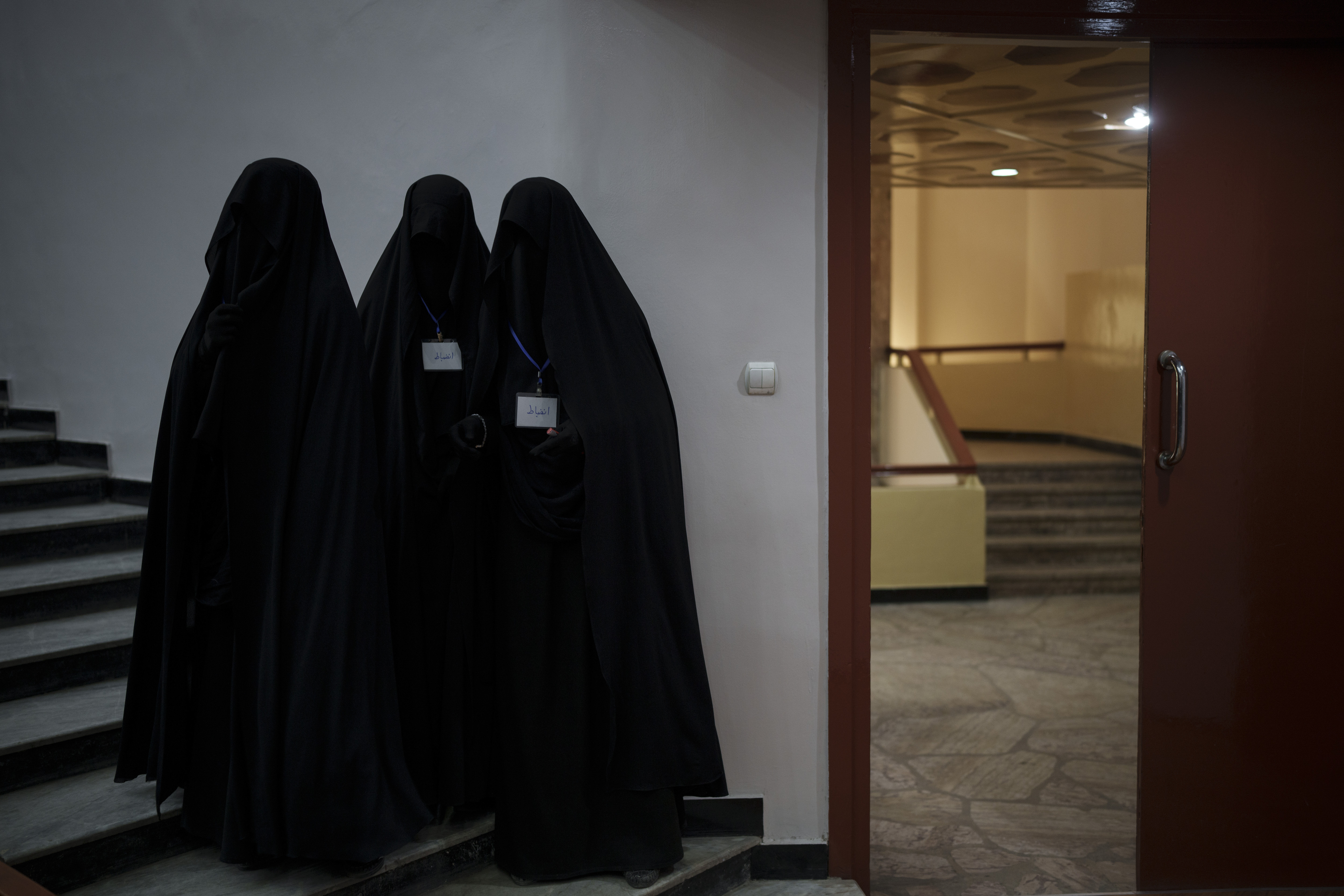 Women stand inside an auditorium at Kabul University's education center during a demonstration in support of the Taliban government in Kabul, Afghanistan, Saturday, Sept. 11, 2021. (AP Photo/Felipe Dana)