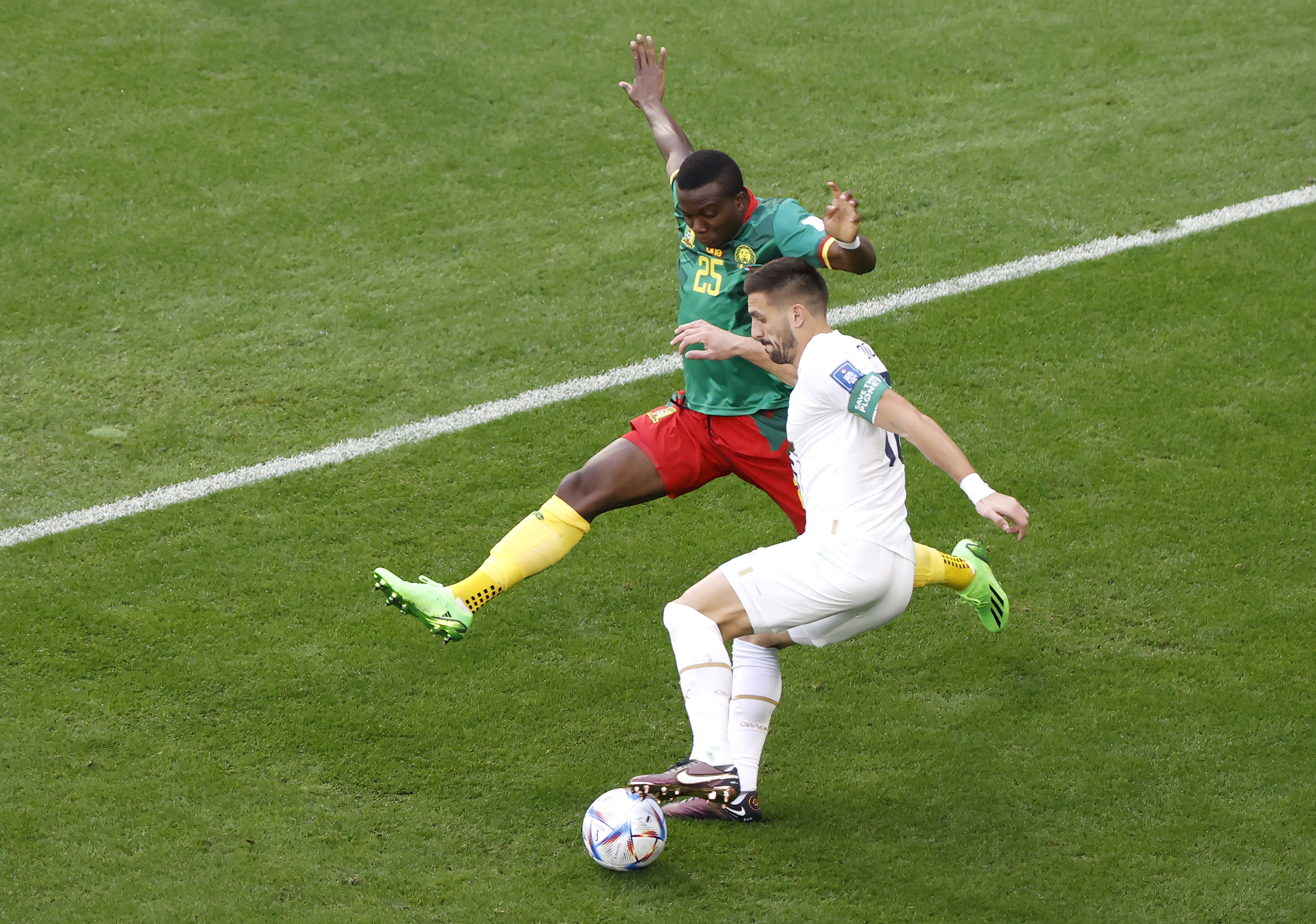 epa10333748 Nouhou Tolo (L) of Cameroon in action against Dusan Tadic of Serbia during the FIFA World Cup 2022 group G soccer match between Cameroon and Serbia at Al Janoub Stadium in Al Wakrah, Qatar, 28 November 2022.  EPA-EFE/Rolex dela Pena