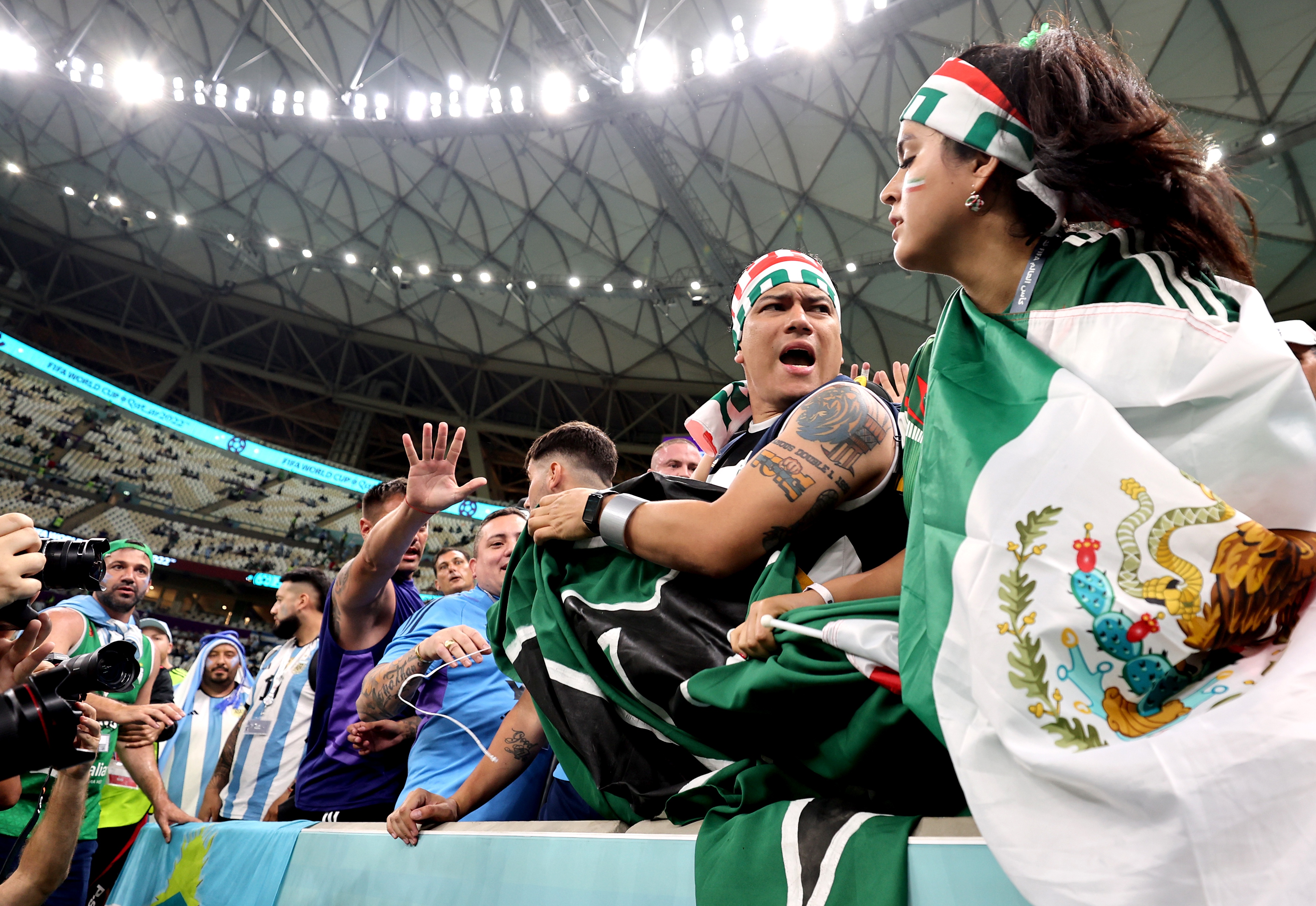 epa10330884 Fans of Argentina (blue) encounter in the stands with fans of Mexico (green) before the FIFA World Cup 2022 group C soccer match between Argentina and Mexico at Lusail Stadium in Lusail, Qatar, 26 November 2022.  EPA-EFE/Mohamed Messara