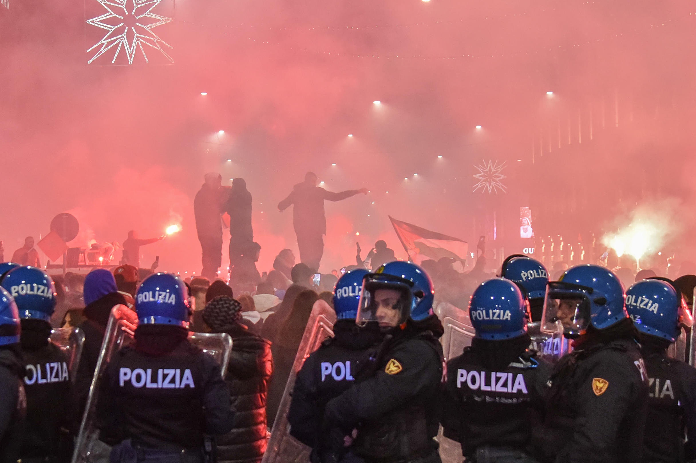 epa10359897 Anti-riot police stand deploy as supporters of Morocco celebrate their team winning the FIFA World Cup 2022 quarter final match between Morocco and Portugal, in Milan, Italy, 10 December 2022.  EPA-EFE/MATTEO CORNER ITALY OUT