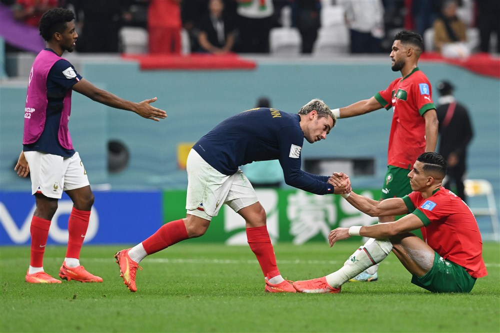 epa10366335 Antoine Griezmann (C) of France and Jawad El Yamiq of Morocco react after the FIFA World Cup 2022 semi final between France and Morocco at Al Bayt Stadium in Al Khor, Qatar, 14 December 2022.  EPA-EFE/Georgi Licovski