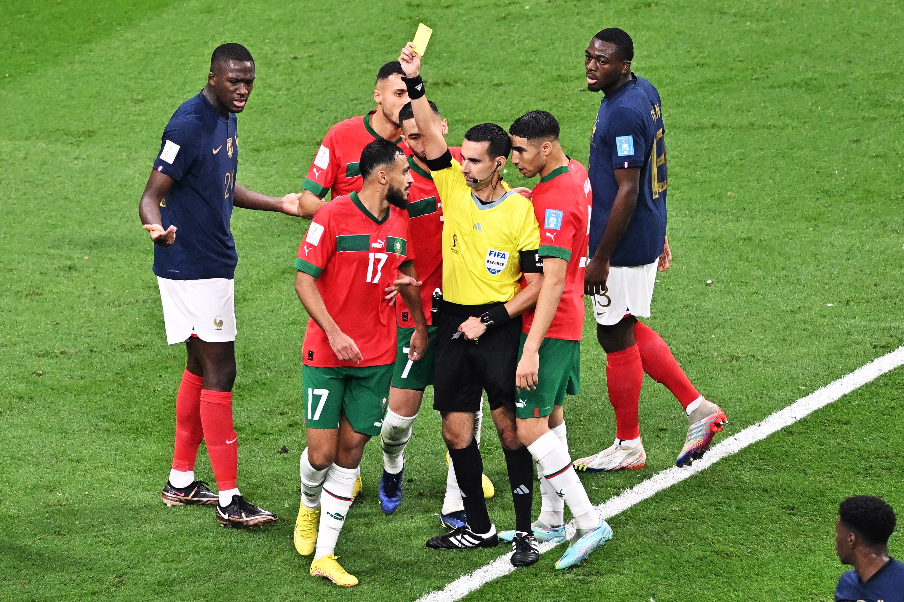 epa10365906 Referee Cesar Arturo Ramos shows a yellow card to Sofiane Boufal of Morocco during the FIFA World Cup 2022 semi final between France and Morocco at Al Bayt Stadium in Al Khor, Qatar, 14 December 2022.  EPA-EFE/Noushad Thekkayil