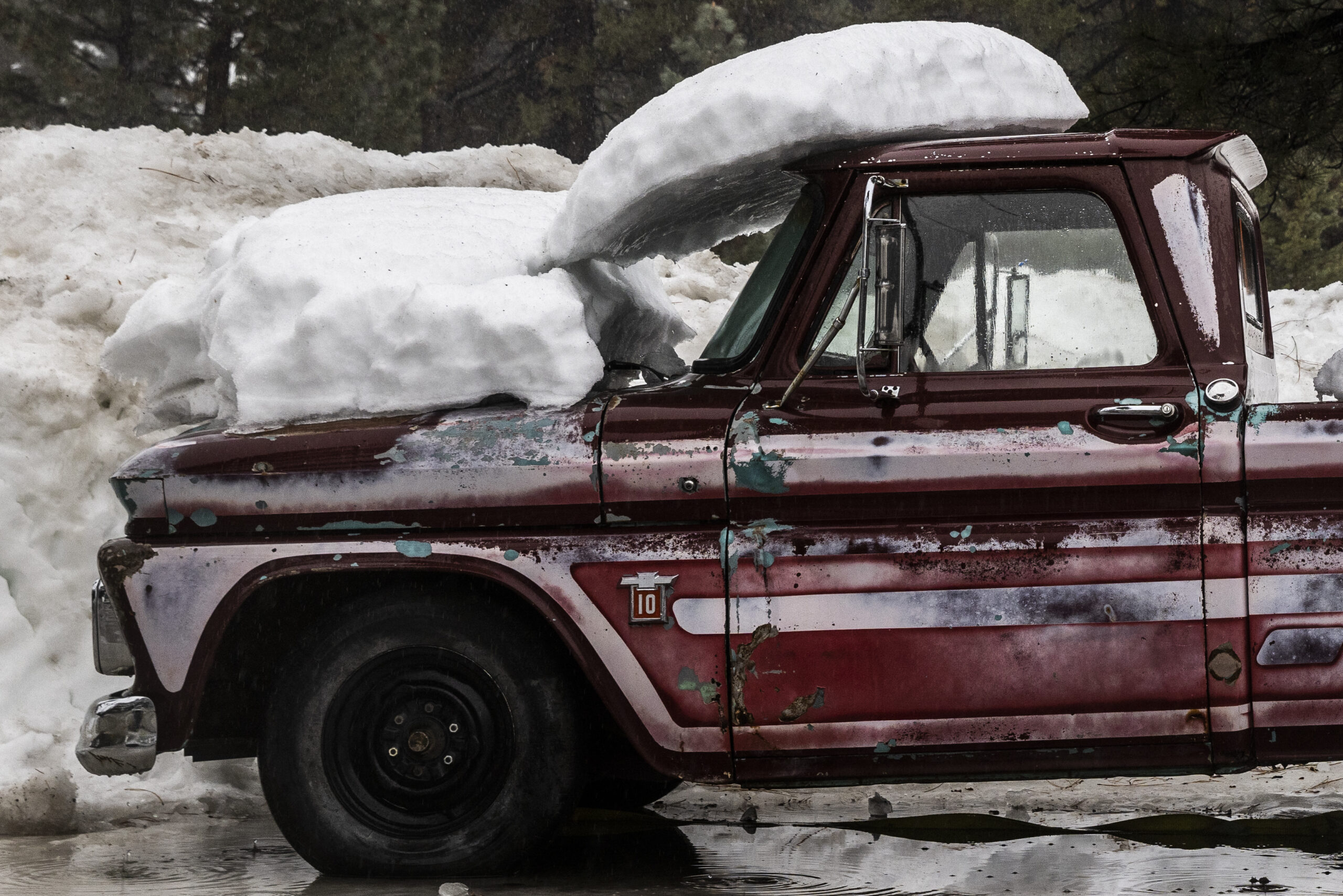 Snow is seen on a Chevrolet C10 pickup truck along U.S. Route 50 in South Lake Tahoe Calif., Friday, Dec. 30, 2022. (Stephen Lam/San Francisco Chronicle via AP)