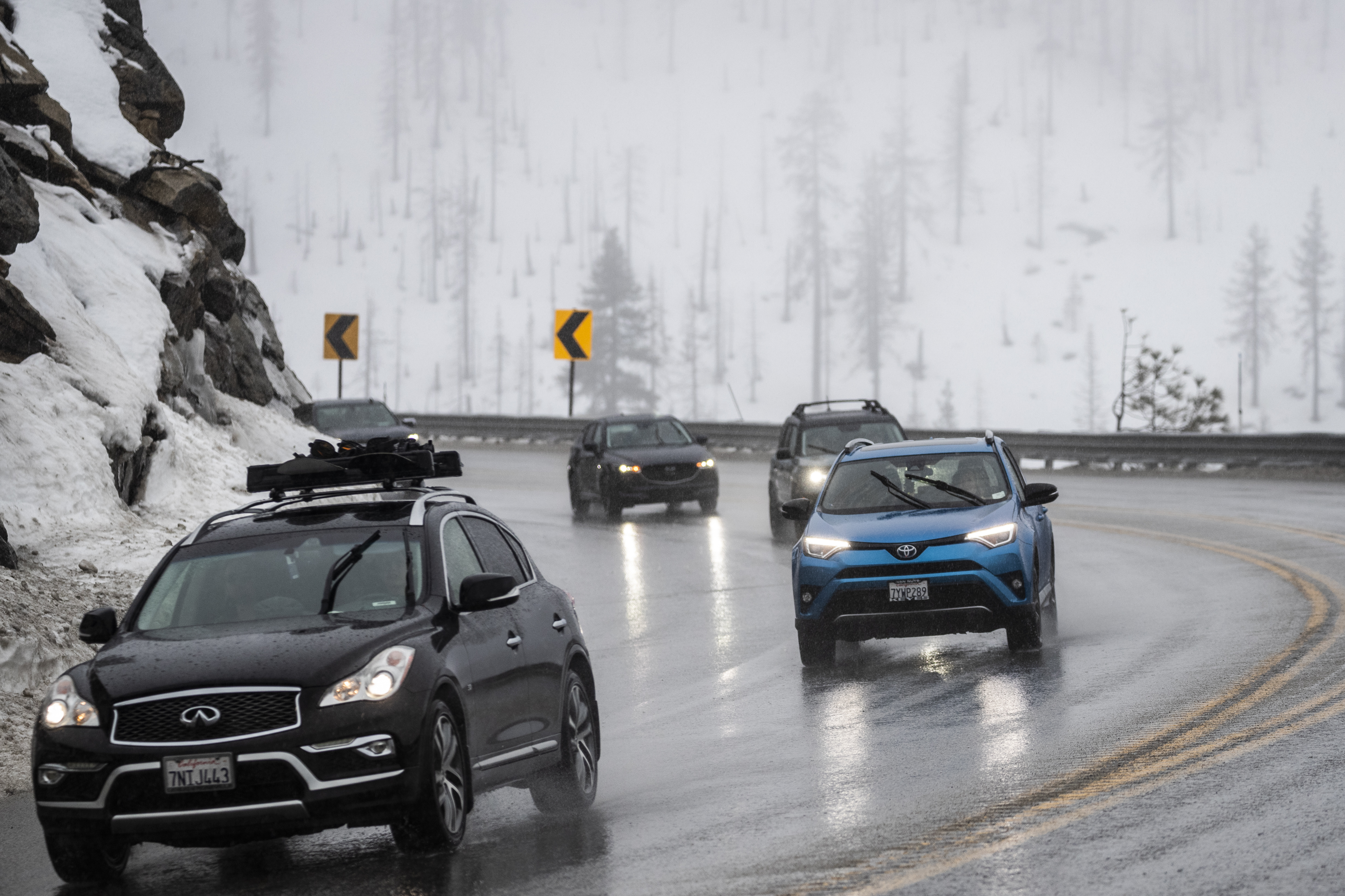 Motorists travel along U.S. Route 50 under steady rain near Twin Bridges, Calif., Friday, Dec. 30, 2022. (Stephen Lam/San Francisco Chronicle via AP)