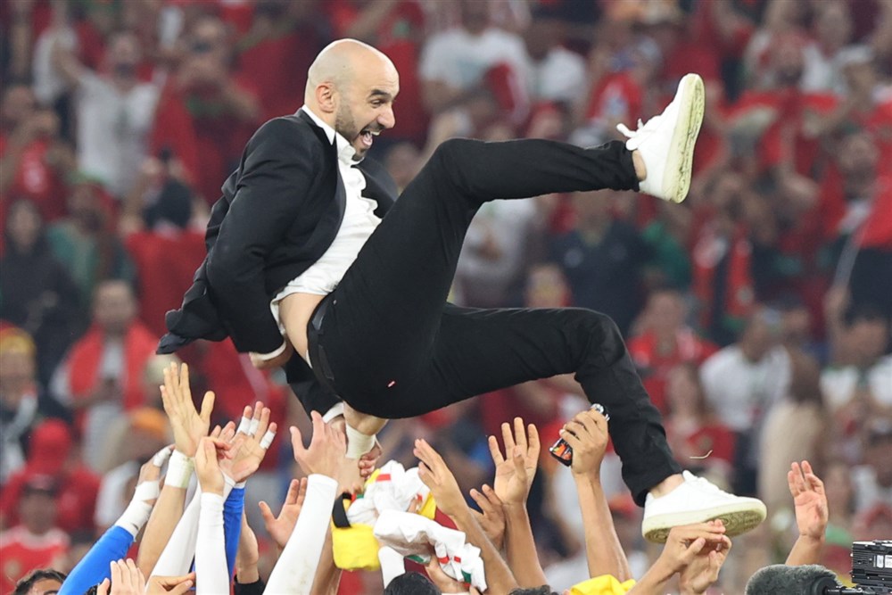epa10342165 Head coach Walid Regragui of Morocco is tossed in the air after the FIFA World Cup 2022 group F soccer match between Canada and Morocco at Al Thumama Stadium in Doha, Qatar, 01 December 2022.  EPA-EFE/Mohamed Messara