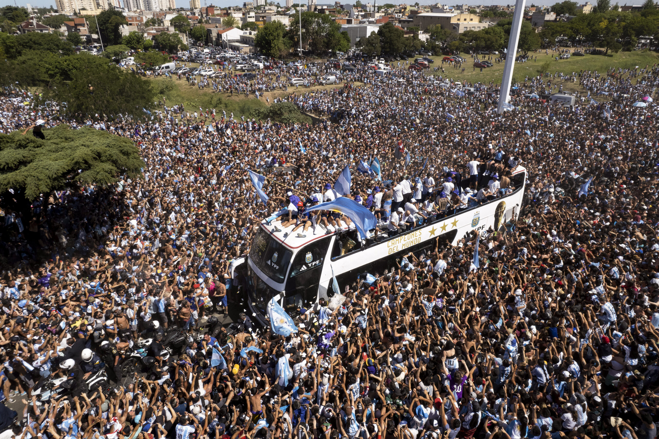 The Argentine soccer team that won the World Cup title ride on an open bus during their homecoming parade in Buenos Aires, Argentina, Tuesday, Dec. 20, 2022. (AP Photo/Rodrigo Abd)