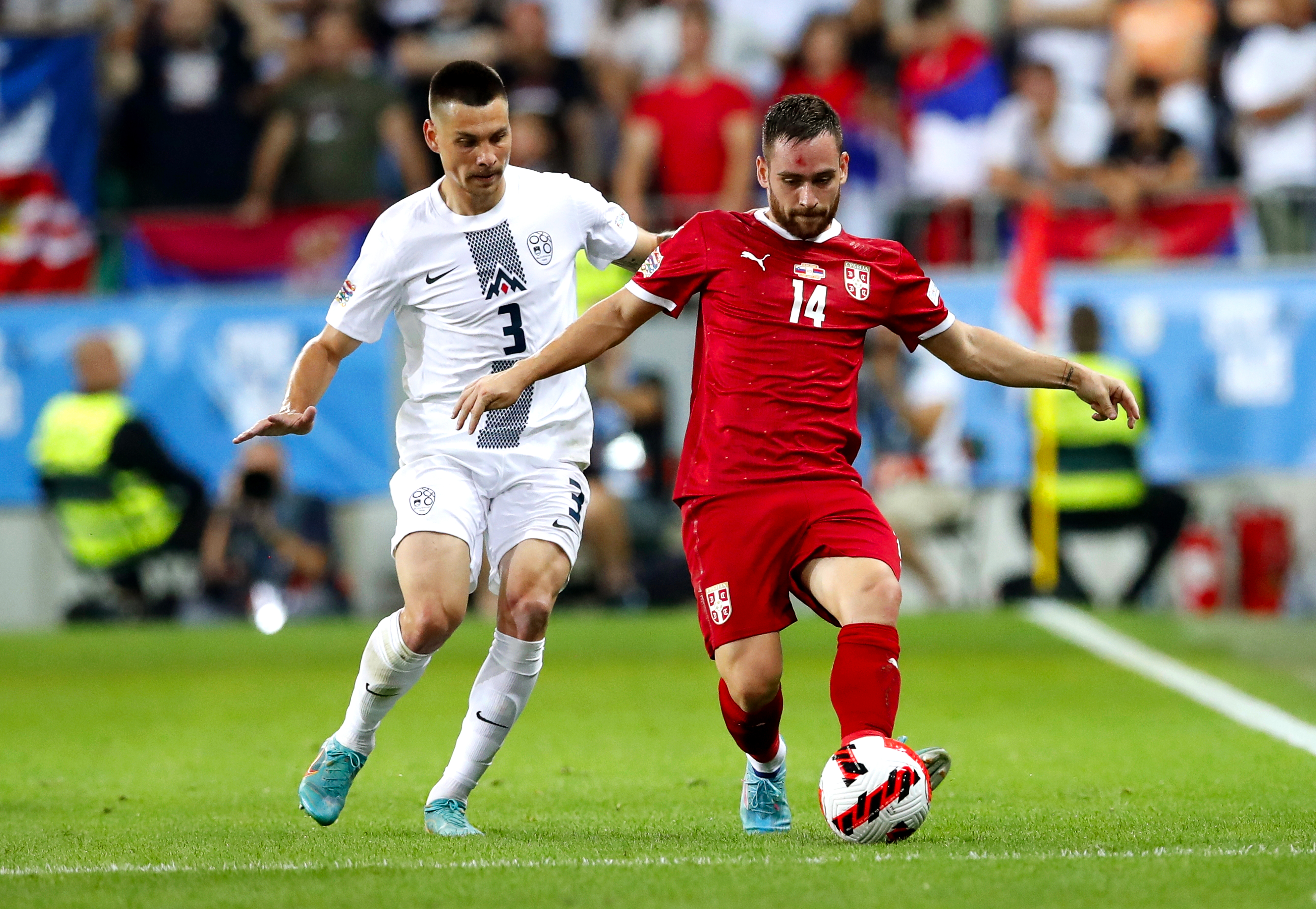 epa10009992 Gregor Sikosek (L) of Slovenia in action against Andrija Zivkovic (R) of Serbia during the UEFA Nations League soccer match between Slovenia and Serbia in Ljubljana, Slovenia, 12 June 2022.  EPA-EFE/ANTONIO BAT