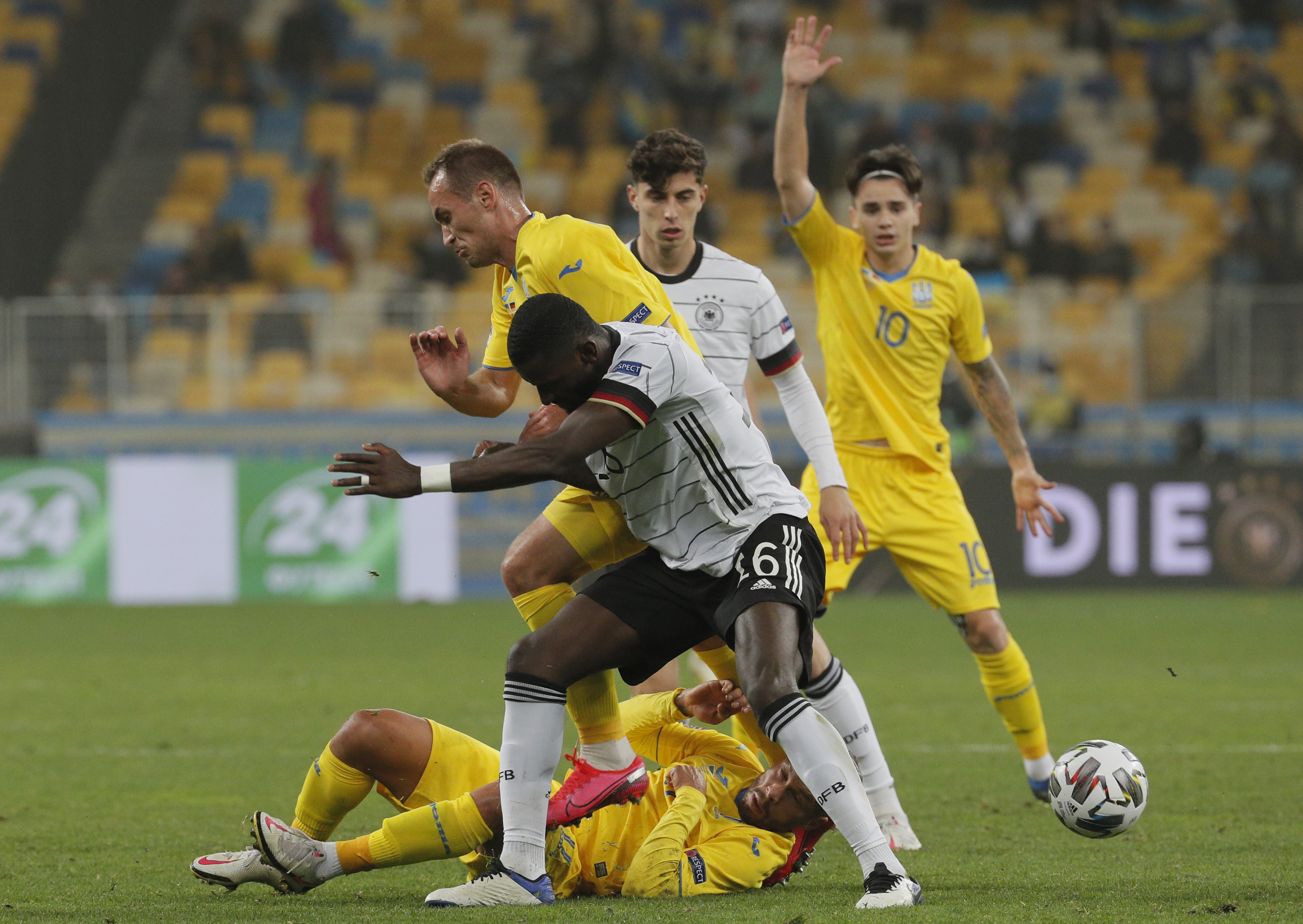 epa08735027 Antonio Rudiger (C front) of Germany and Marlos (C down) of Ukraine in action during the UEFA Nations League group stage, league A, group 4 soccer match between Ukraine and Germany in Kiev, Ukraine, 10 October 2020.  EPA-EFE/SERGEY DOLZHENKO