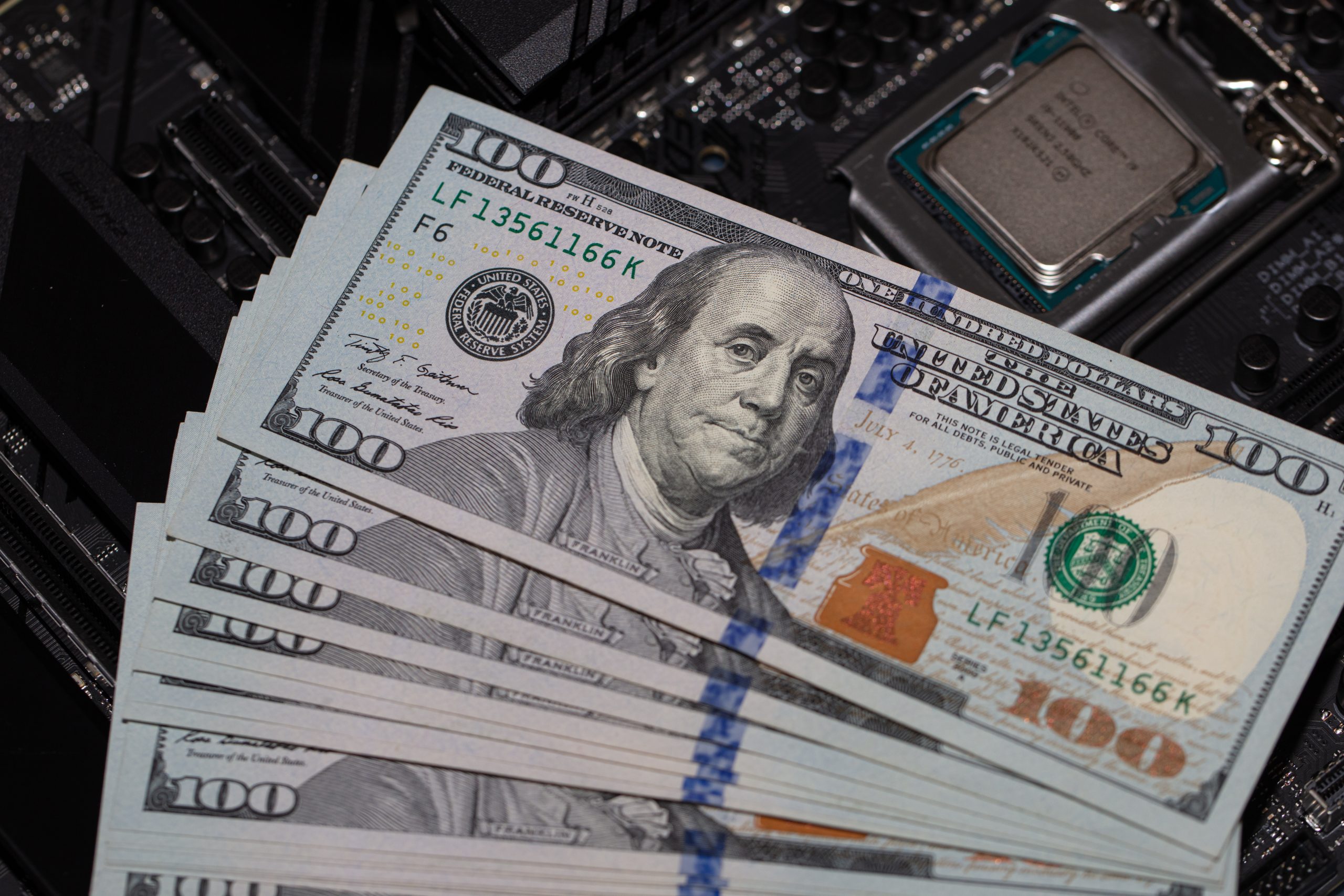 California, U.S. - August 21, 2021: Closeup of Intel Core i9-11900 Processor and 100 dollar banknotes