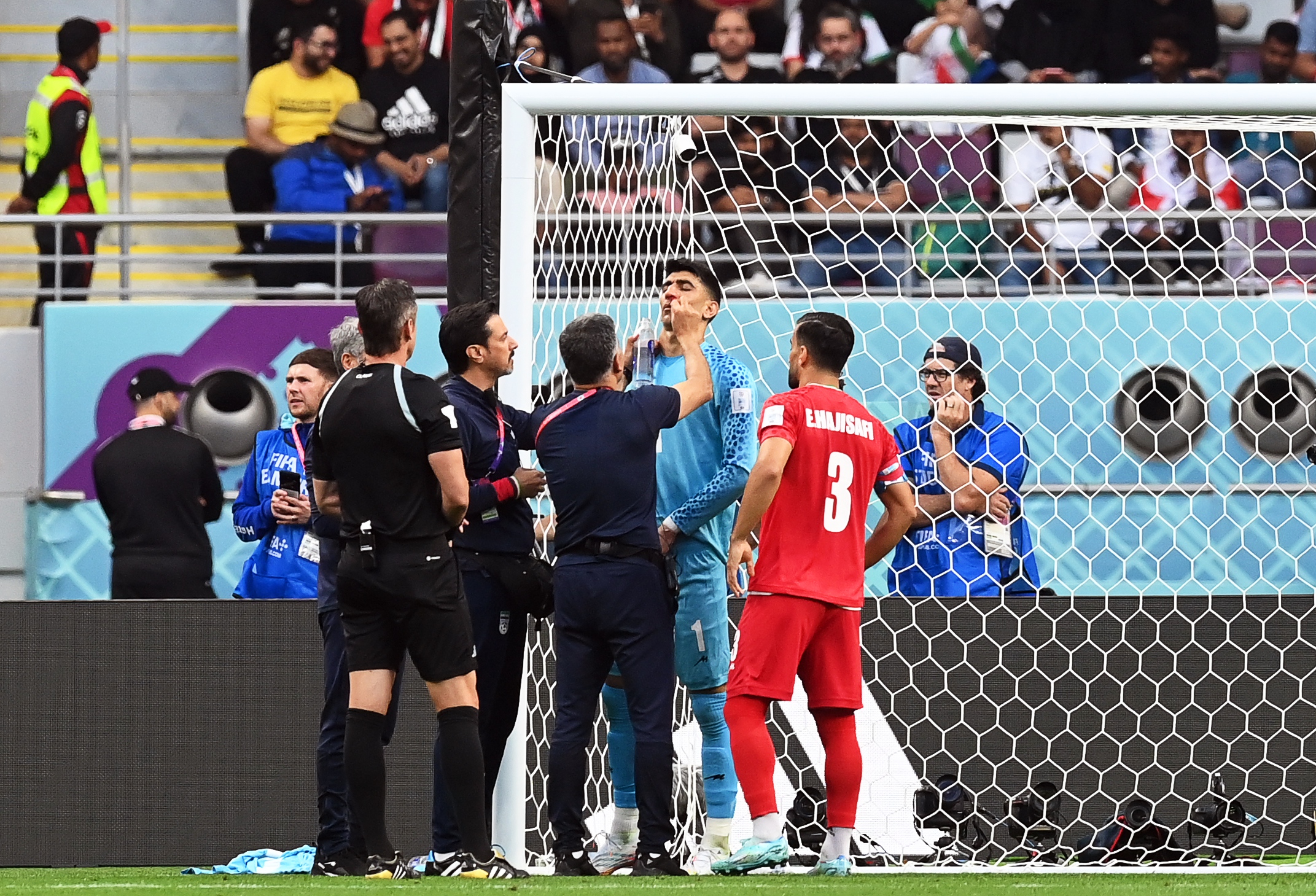 epa10317864 Iran's goalkeeper Alireza Beiranvand (2-R) receives medical assistance during the FIFA World Cup 2022 group B soccer match between England and Iran at Khalifa International Stadium in Doha, Qatar, 21 November 2022.  EPA-EFE/Neil Hall