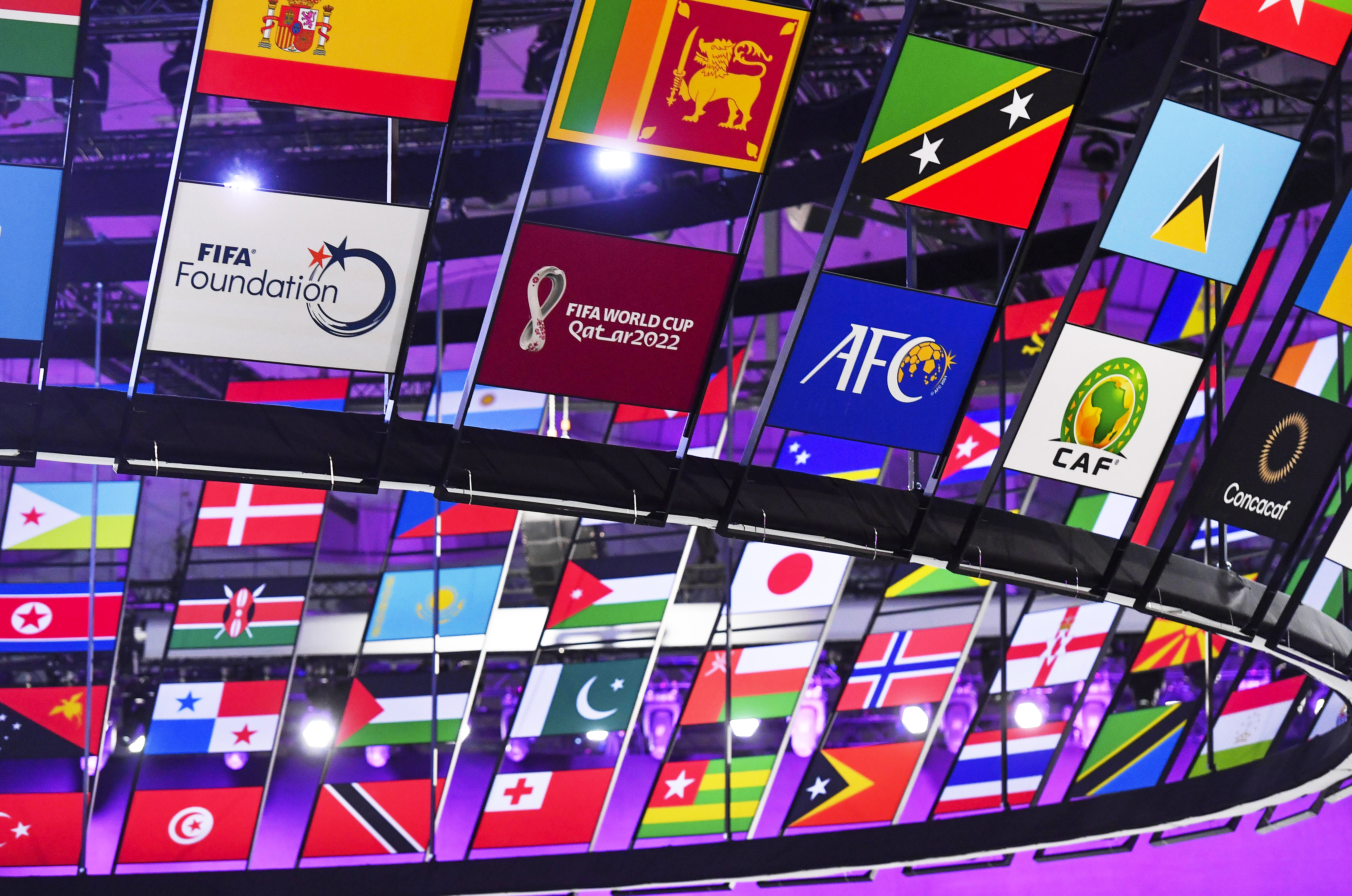 epa09861682 A FIFA World Cup Qatar 2022 sign among flags of countries and soccer federations during the 72nd FIFA Congress in Doha, Qatar, 31 March 2022.  EPA-EFE/NOUSHAD THEKKAYIL