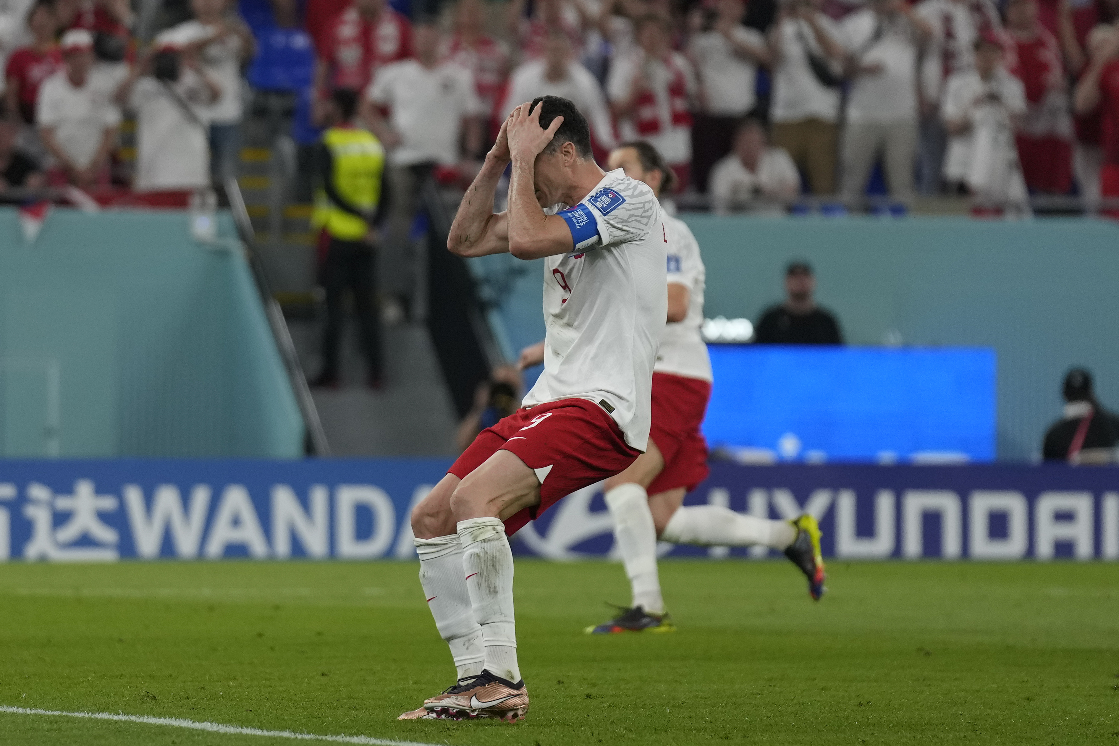 Poland's Robert Lewandowski reacts after missing a penalty during the World Cup group C soccer match between Mexico and Poland, at the Stadium 974 in Doha, Qatar, Tuesday, Nov. 22, 2022. (AP Photo/Aijaz Rahi)