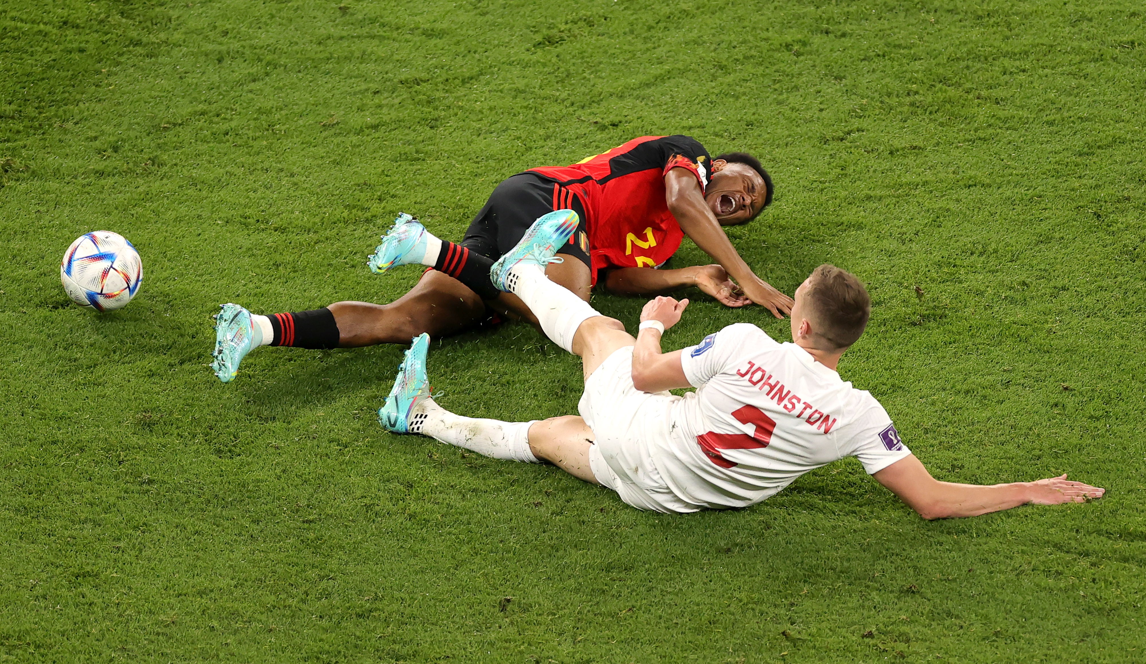 epa10323787 Lois Openda (L) of Belgium is fouled by Alistair Johnston of Canada during the FIFA World Cup 2022 group F soccer match between Belgium and Canada at Ahmad bin Ali Stadium in Doha, Qatar, 23 November 2022.  EPA-EFE/Friedemann Vogel
