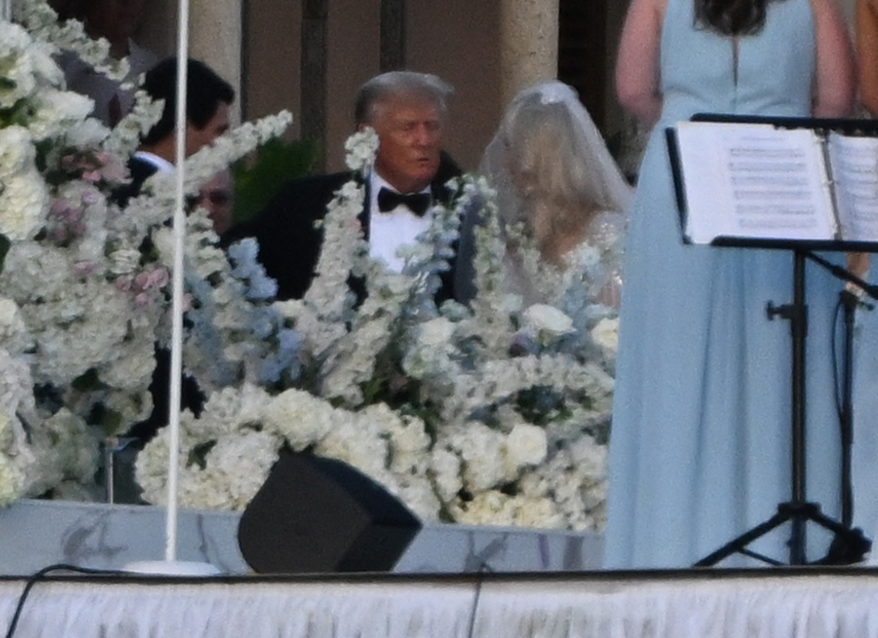 Former US President Donald Trump walks his daughter Tiffany Trump down the isle during her wedding at Mar A Lago