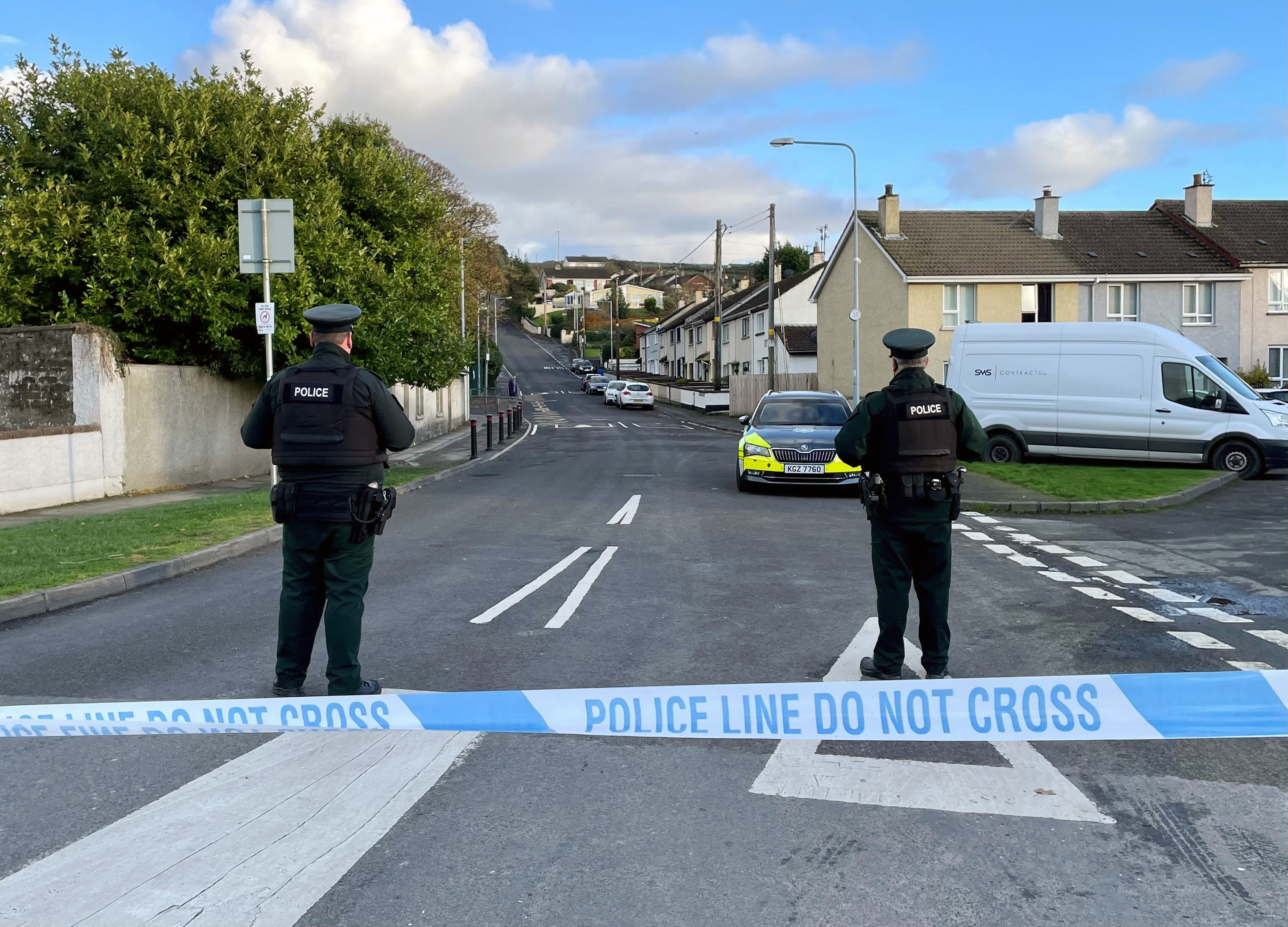 Officers from the Police Service of Northern Ireland (PSNI) stand guard at the scene, following the attempted murder of two officers in Strabane, Northern Ireland, Friday Nov. 18, 2022. (David Young/PA via AP)