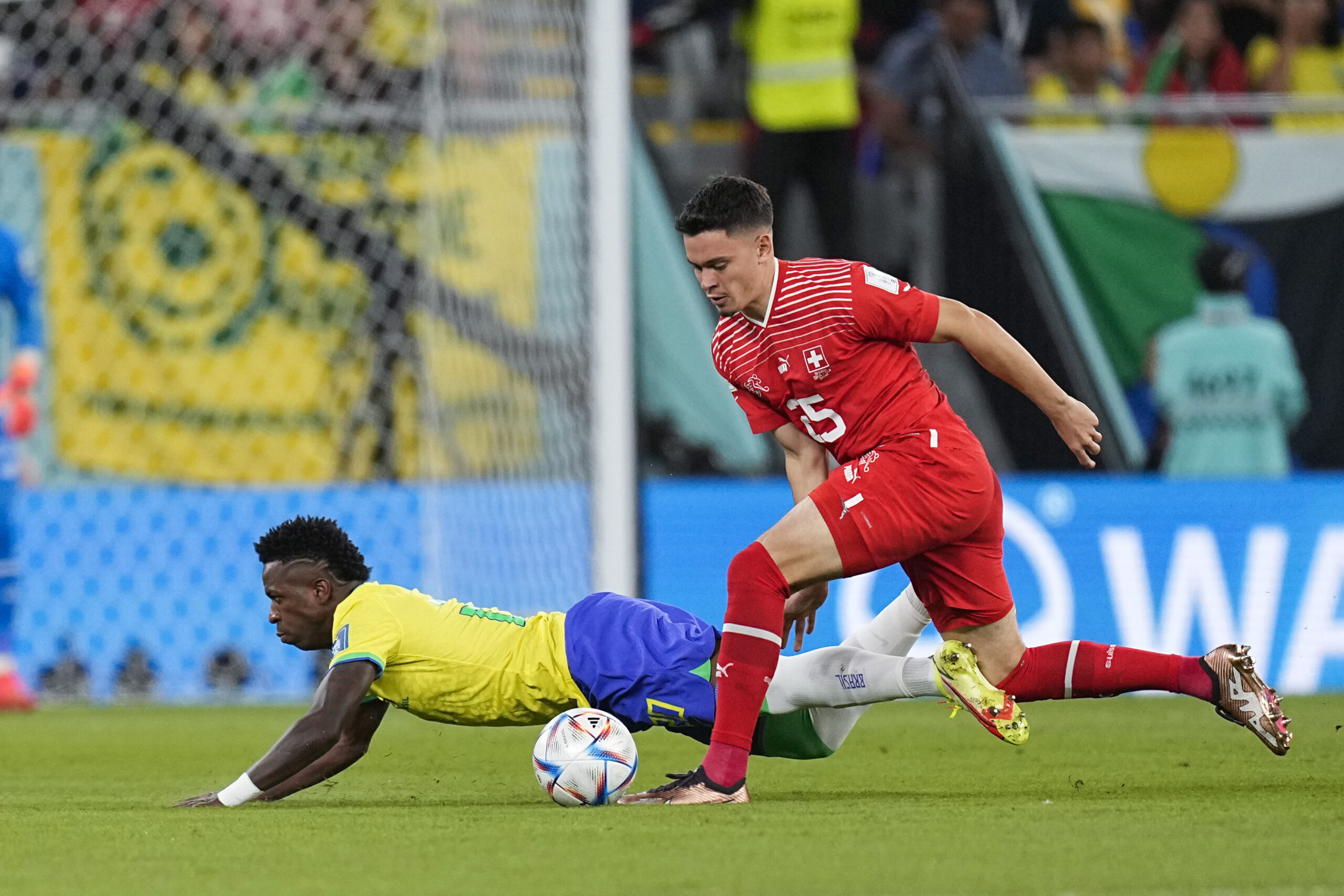 Switzerland's Fabian Rieder, right, vies for the ball with Brazil's Vinicius Junior during the World Cup group G soccer match between Brazil and Switzerland, at the Stadium 974 in Doha, Qatar, Monday, Nov. 28, 2022. (AP Photo/Ariel Schalit)