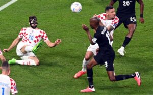 epa10332779 Josko Gvardiol of Croatia (L) clears a ball during the FIFA World Cup 2022 group F soccer match between Croatia and Canada at Khalifa International Stadium in Doha, Qatar, 27 November 2022.  EPA-EFE/Neil Hall