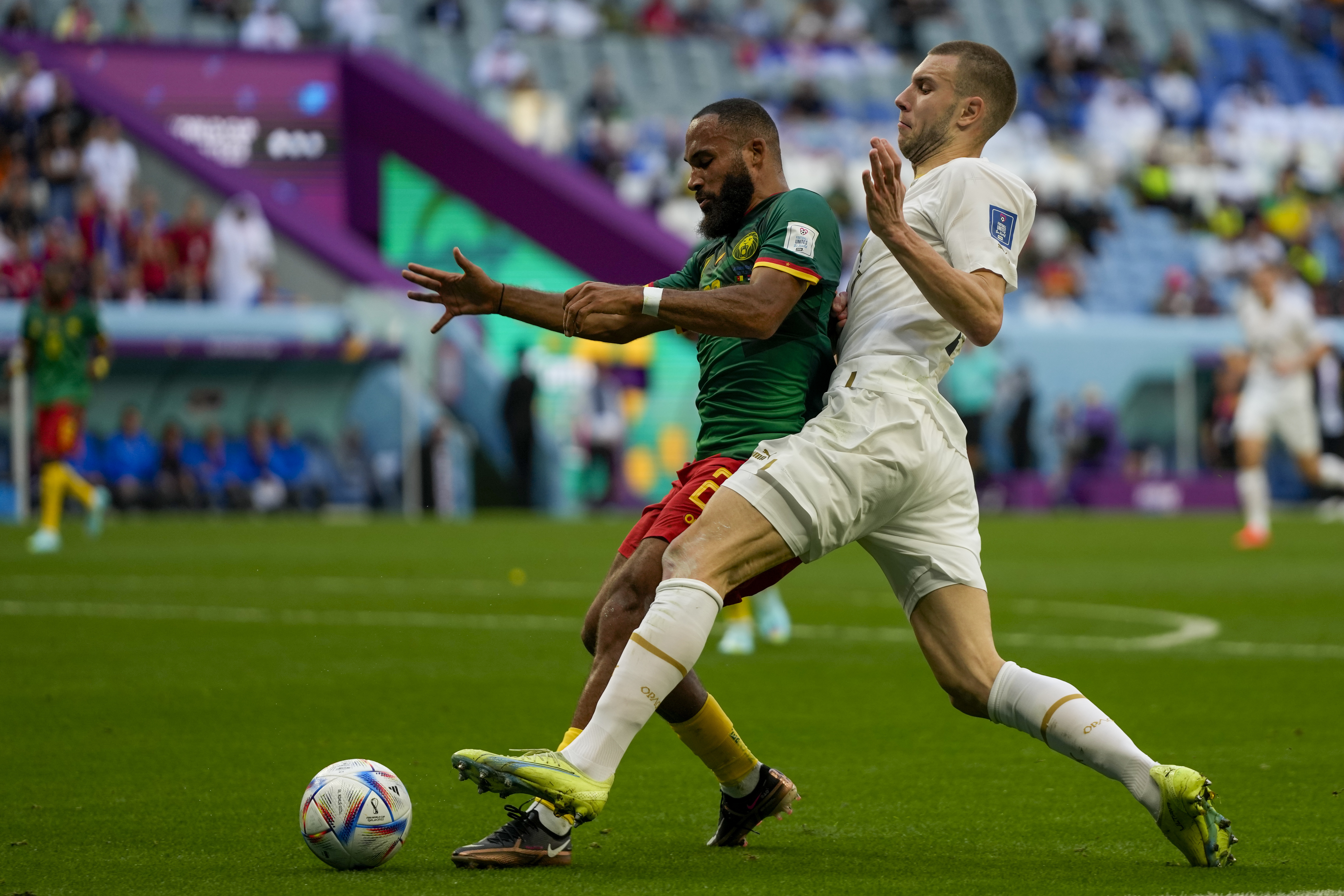Cameroon's Bryan Mbeumo, left, is challenged by Serbia's Strahinja Pavlovic during the World Cup group G soccer match between Cameroon and Serbia, at the Al Janoub Stadium in Al Wakrah, Qatar, Monday, Nov. 28, 2022. (AP Photo/Frank Augstein)