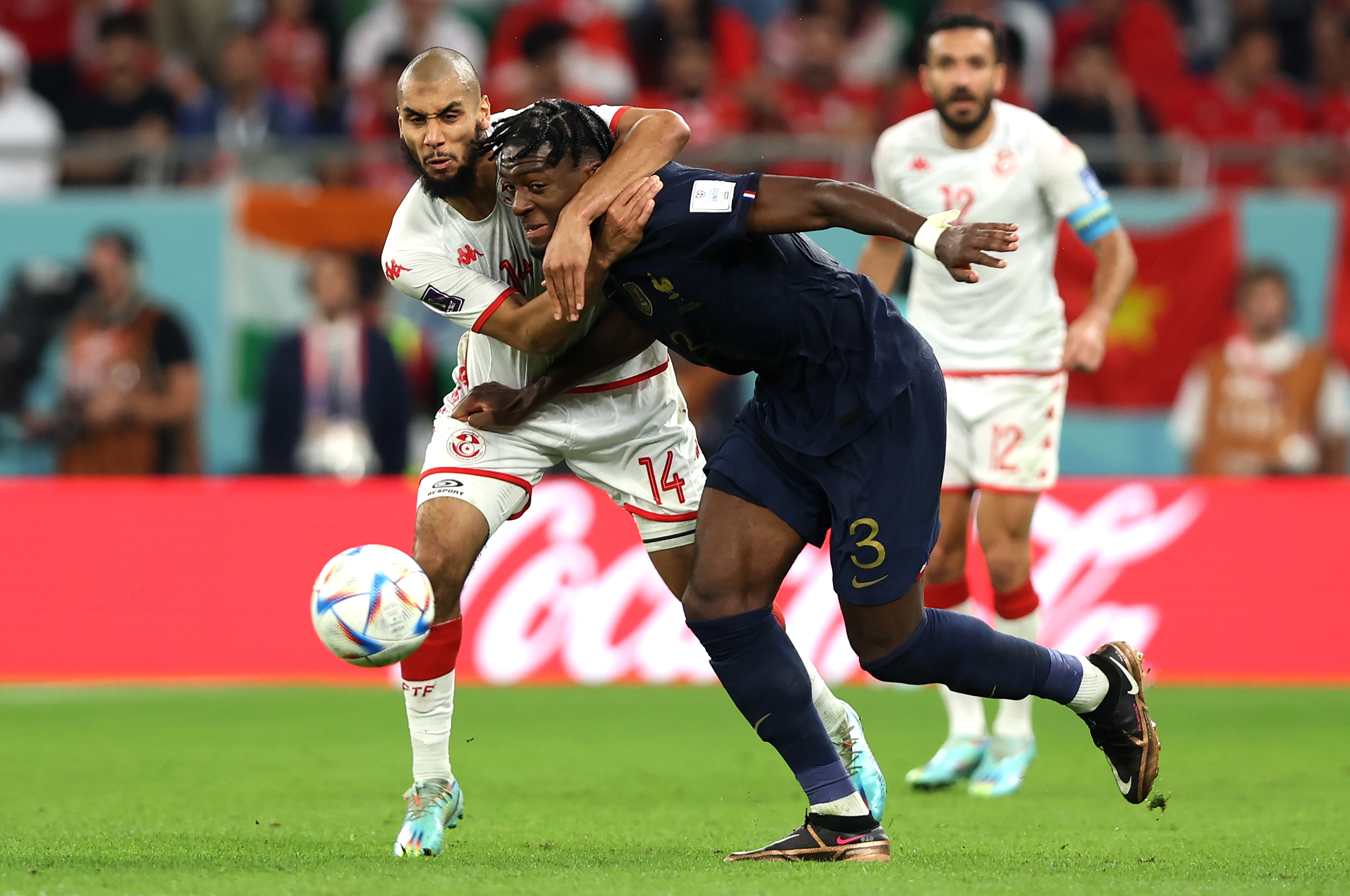 epa10339320 Aissa Laidouni (L) of Tunisia in action against Axel Disasi of France during the FIFA World Cup 2022 group D soccer match between Tunisia and France at Education City Stadium in Doha, Qatar, 30 November 2022.  EPA-EFE/Tolga Bozoglu