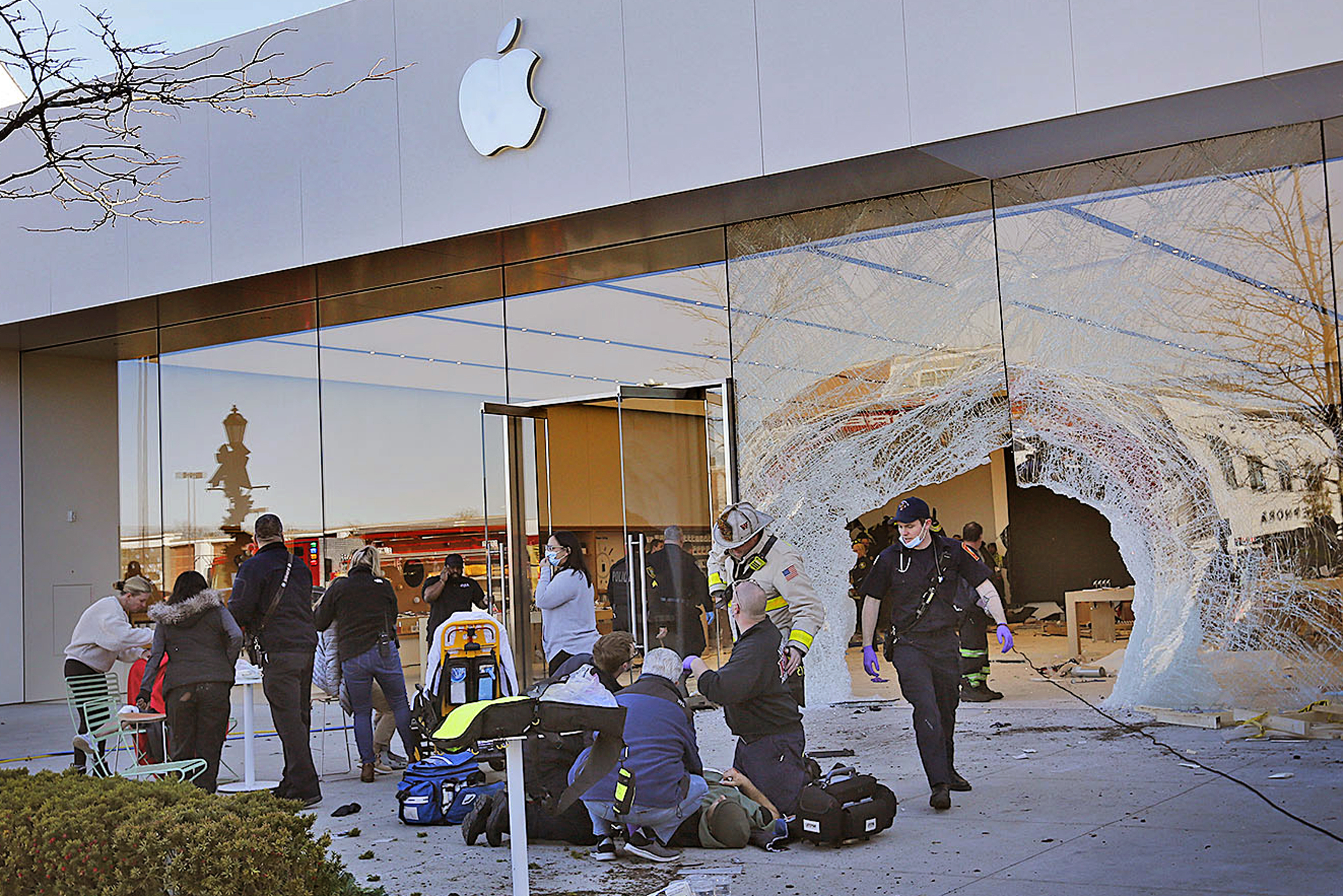 Emergency workers aid injured shoppers after an SUV drove into an Apple store, Monday, Nov. 21, 2022, in Hingham, Mass. Several people were injured in the incident, according to authorities. (Greg Derr/The Patriot Ledger via AP) BOSTON OUT