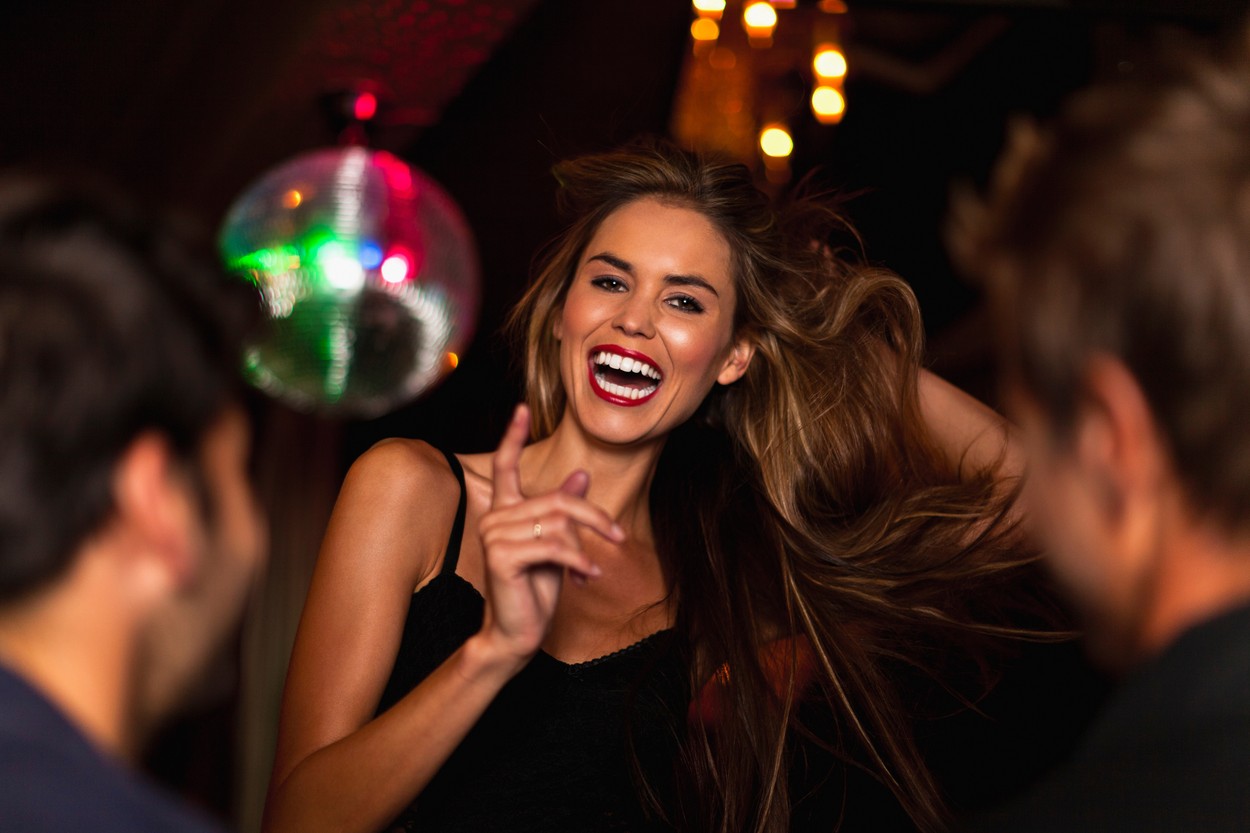 Smiling woman dancing in club