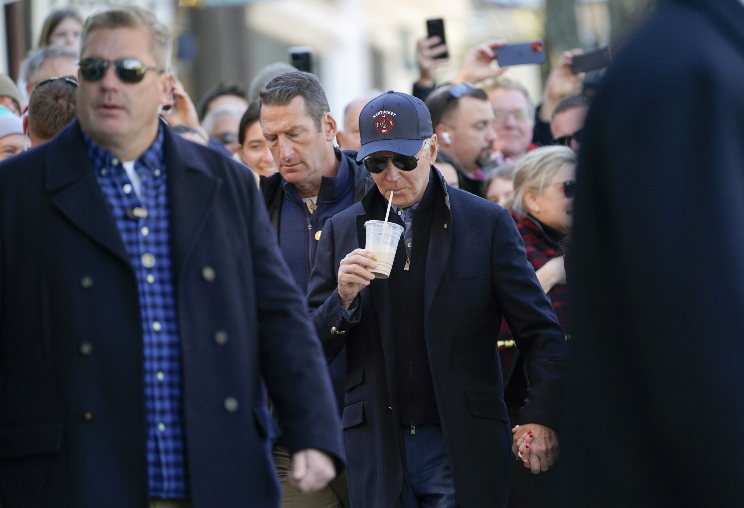President Joe Biden walks by shops with family members in Nantucket, Mass., Saturday, Nov. 26, 2022. (AP Photo/Susan Walsh)