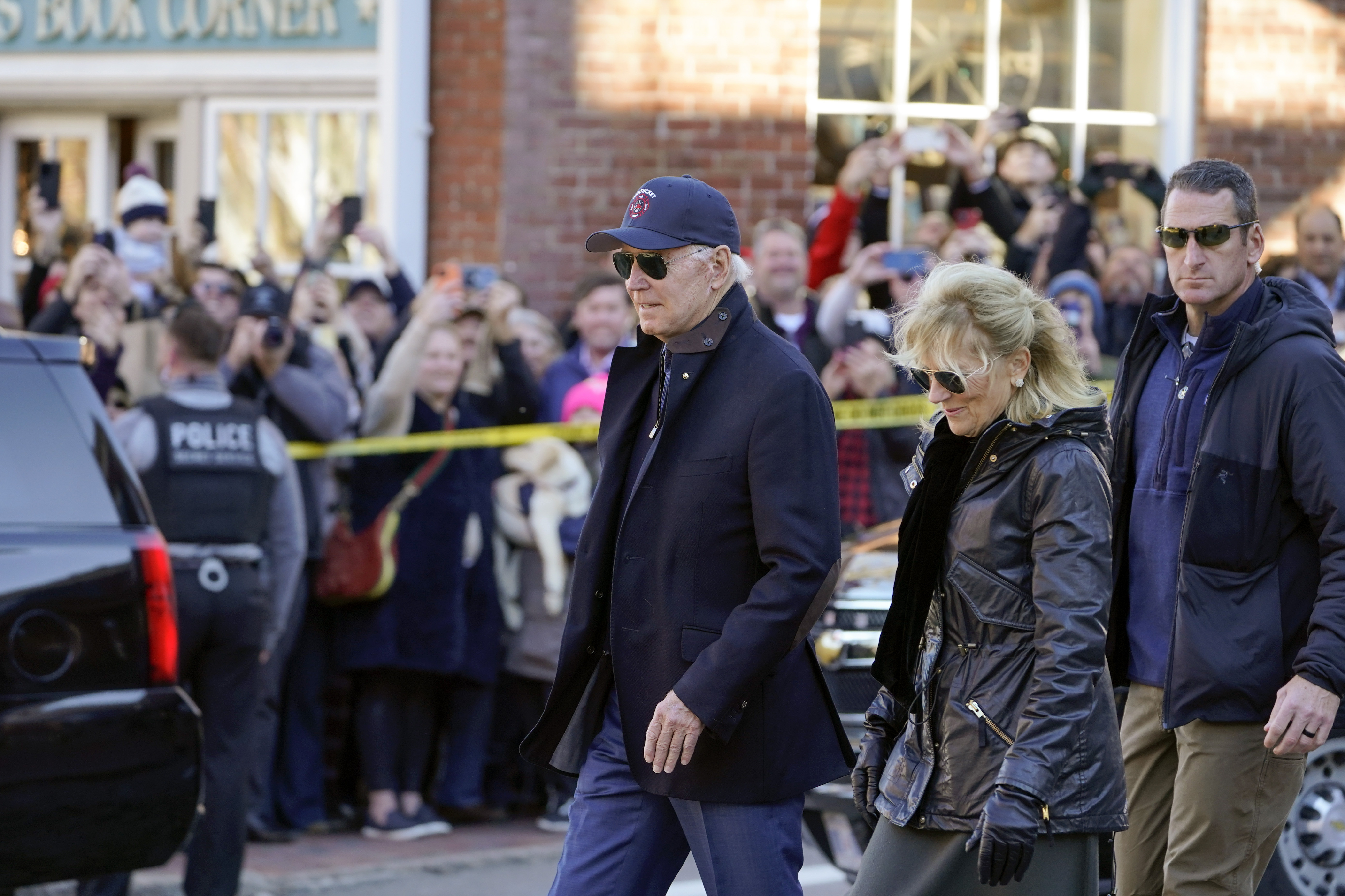 People watch as President Joe Biden and first lady Jill Biden visit shops in Nantucket, Mass., Saturday, Nov. 26, 2022. (AP Photo/Susan Walsh)