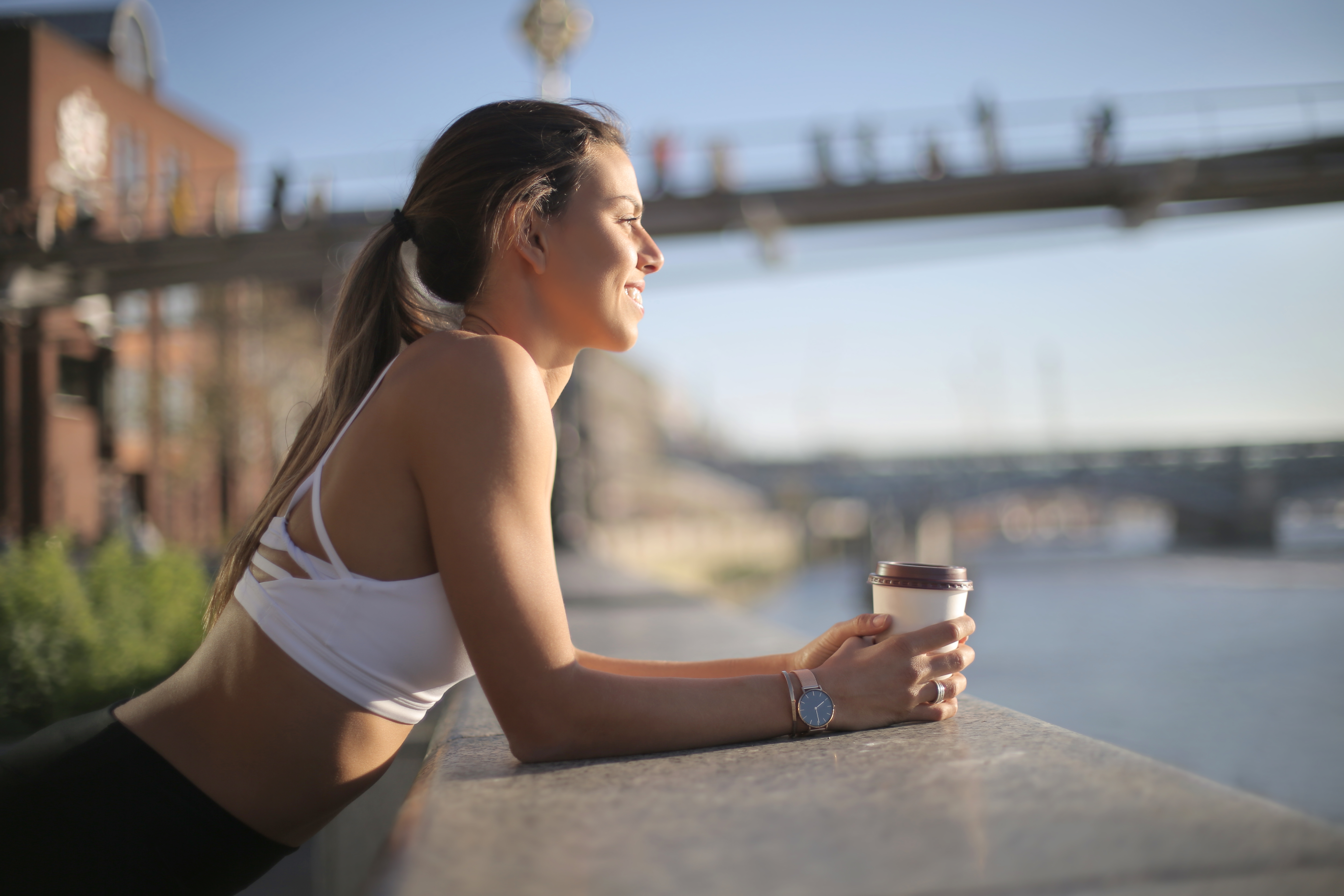 Sportive,Girl,Resting,Drinking,A,Coffee,And,Looking,At,The