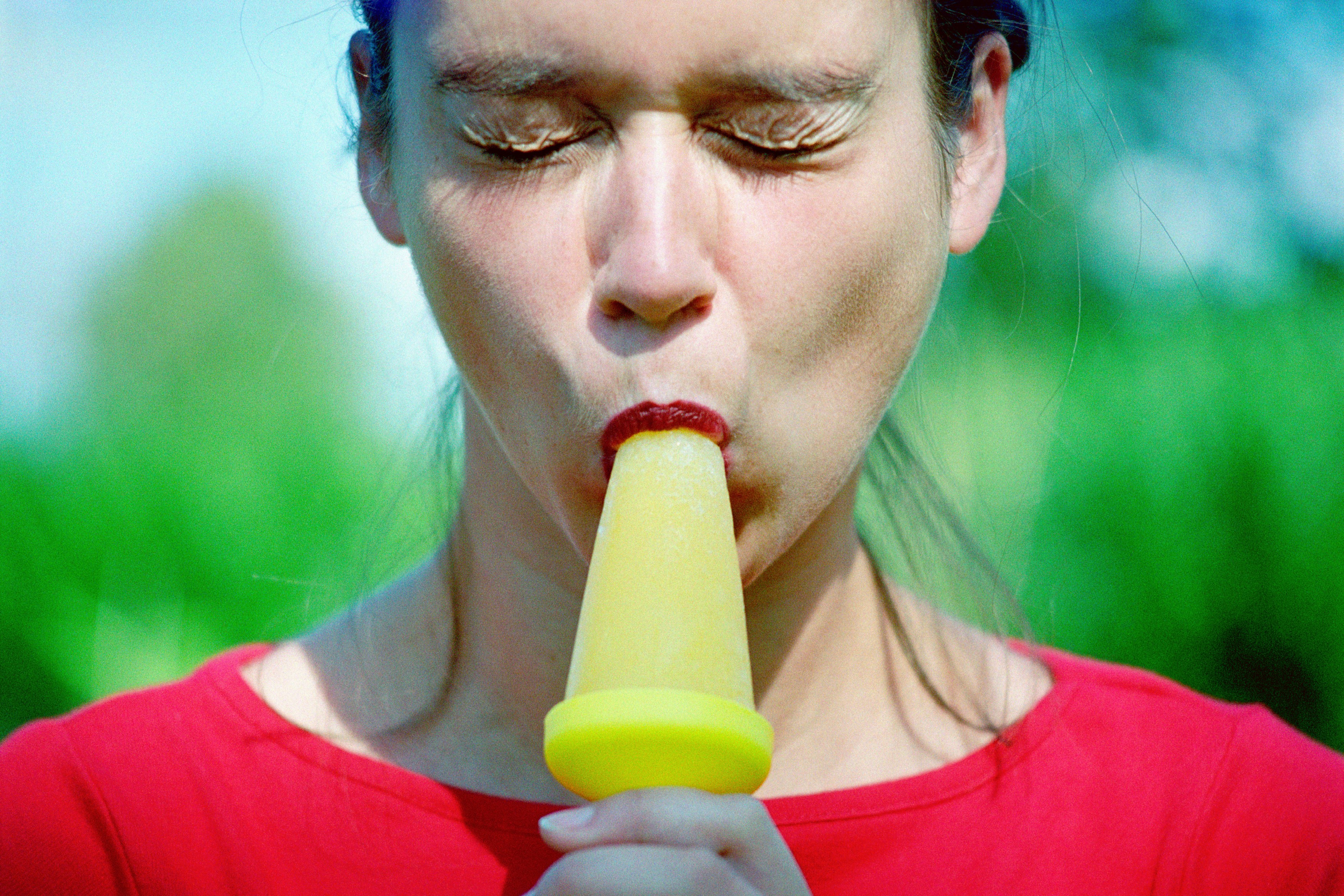 Woman eating an ice lolly