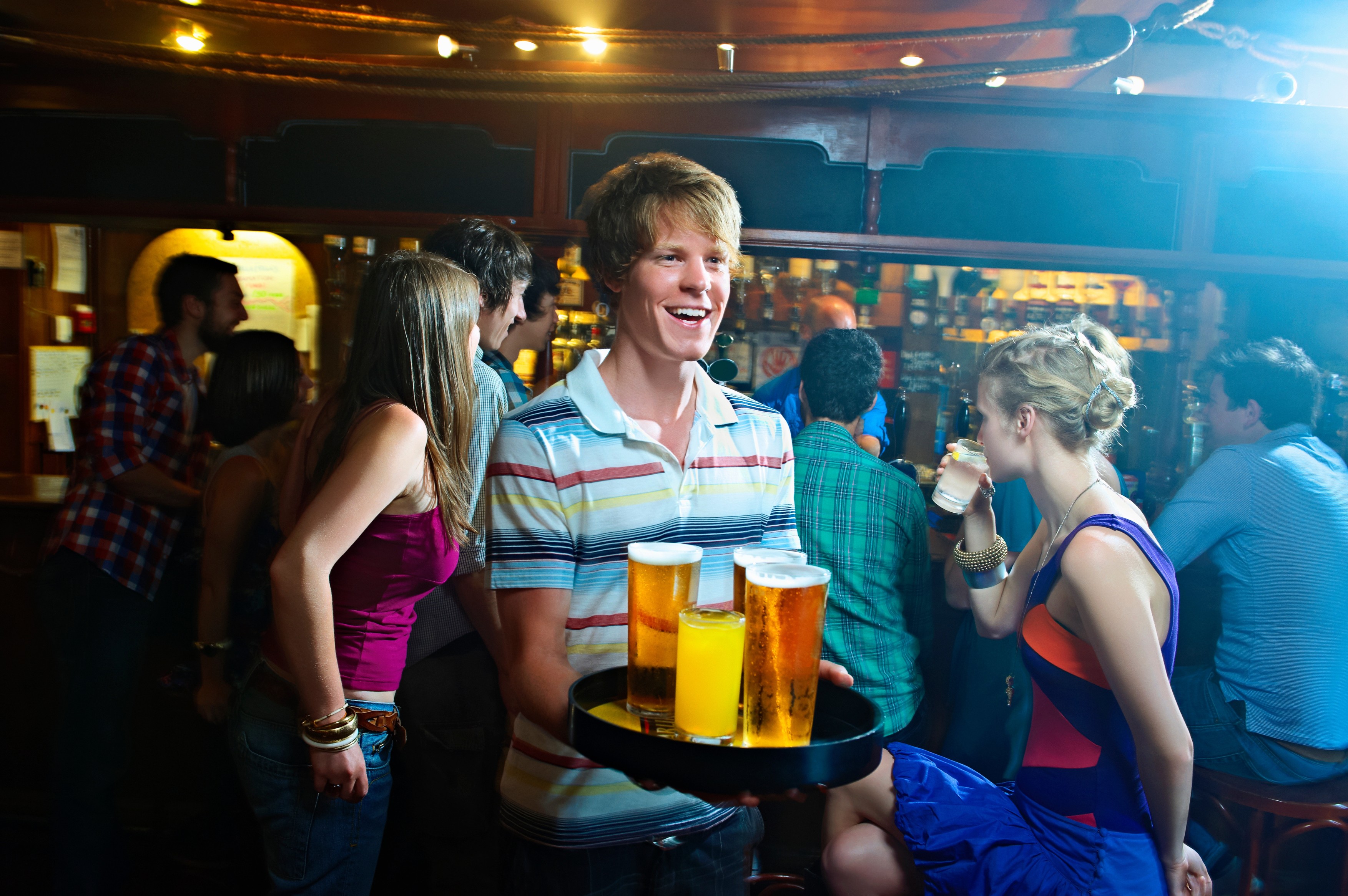 Group of young people drinking in pub