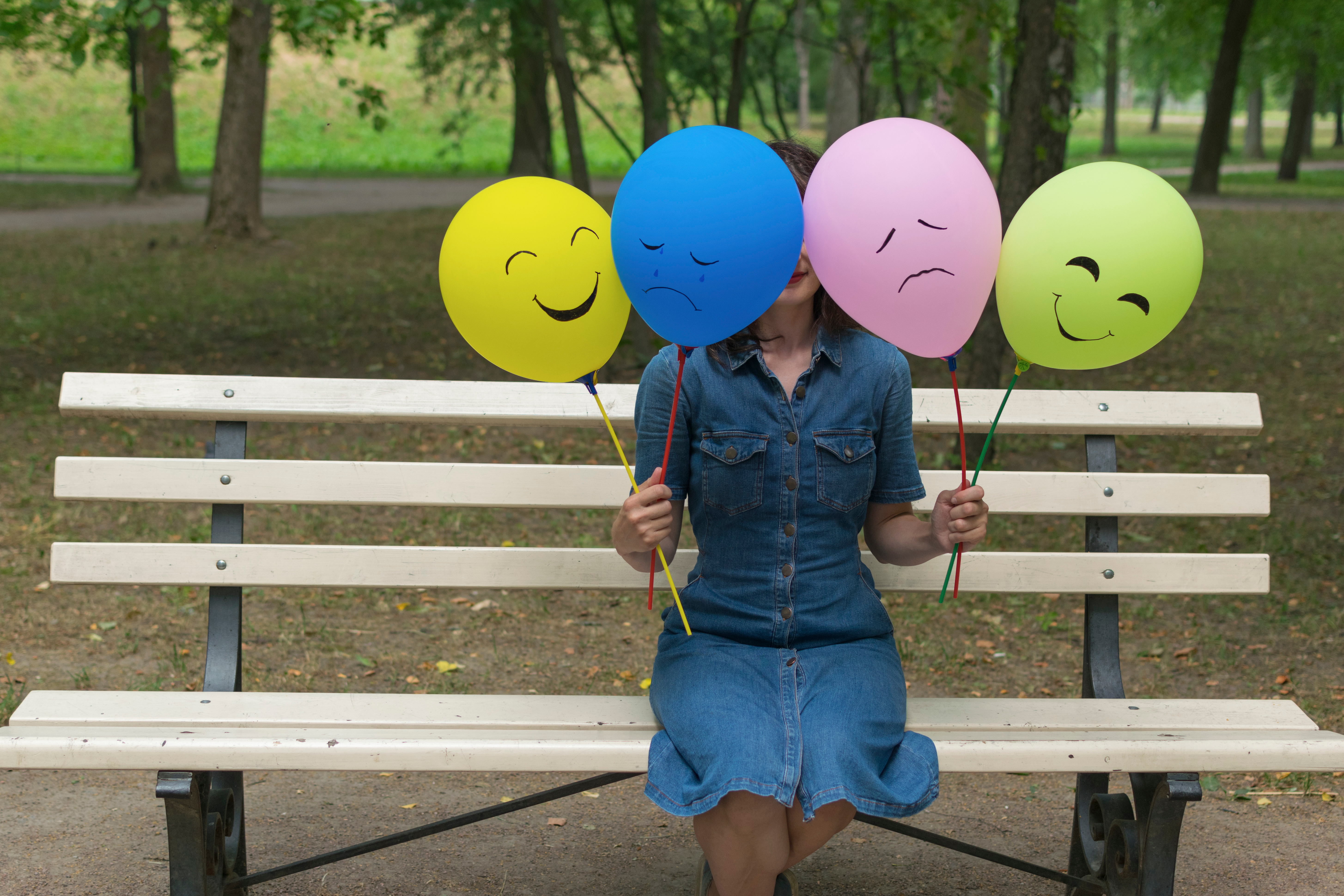 Woman,Holding,Air,Balloons,With,Funny,Faces.