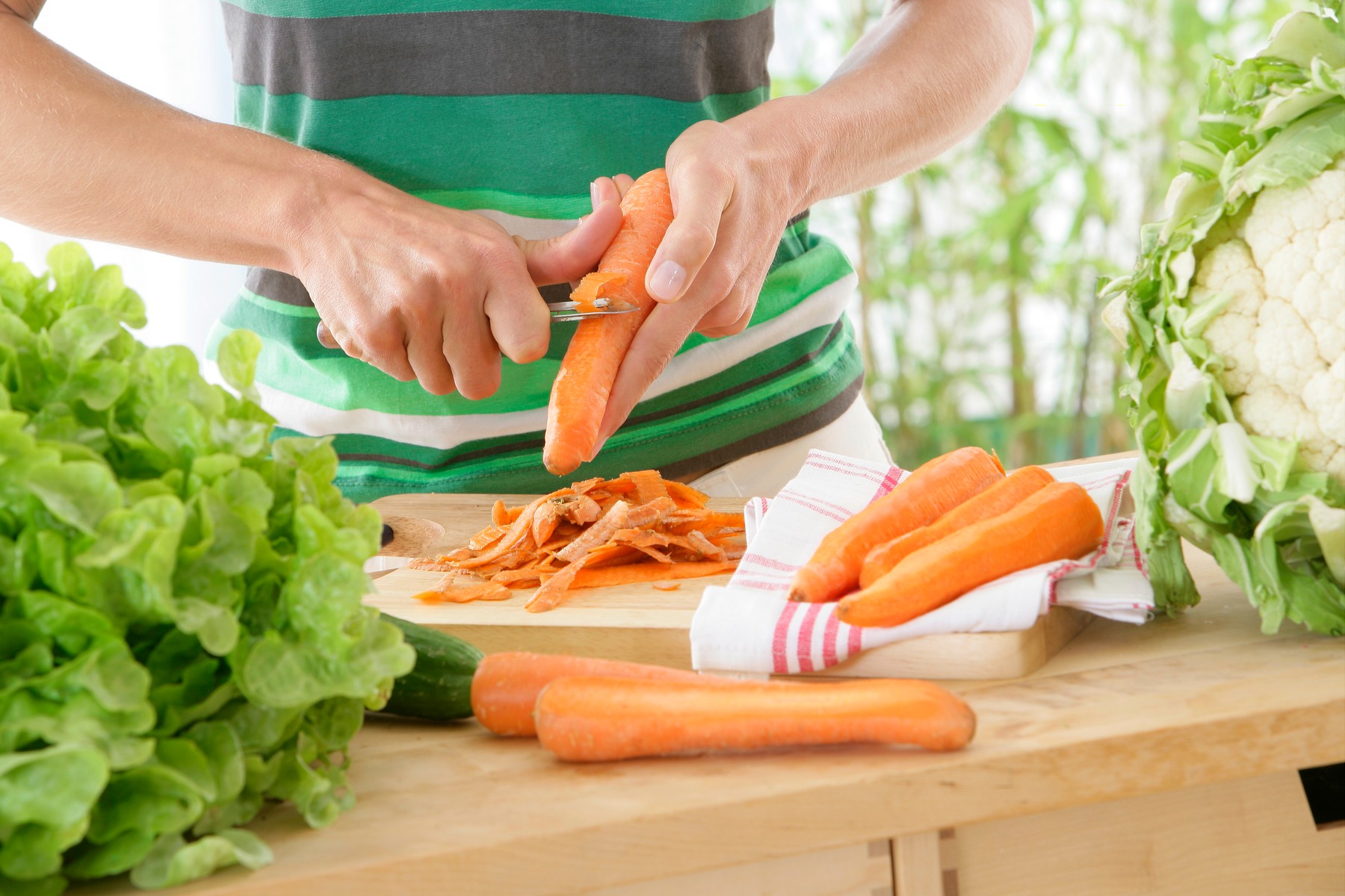 WOMAN EATING RAW VEGETABLES