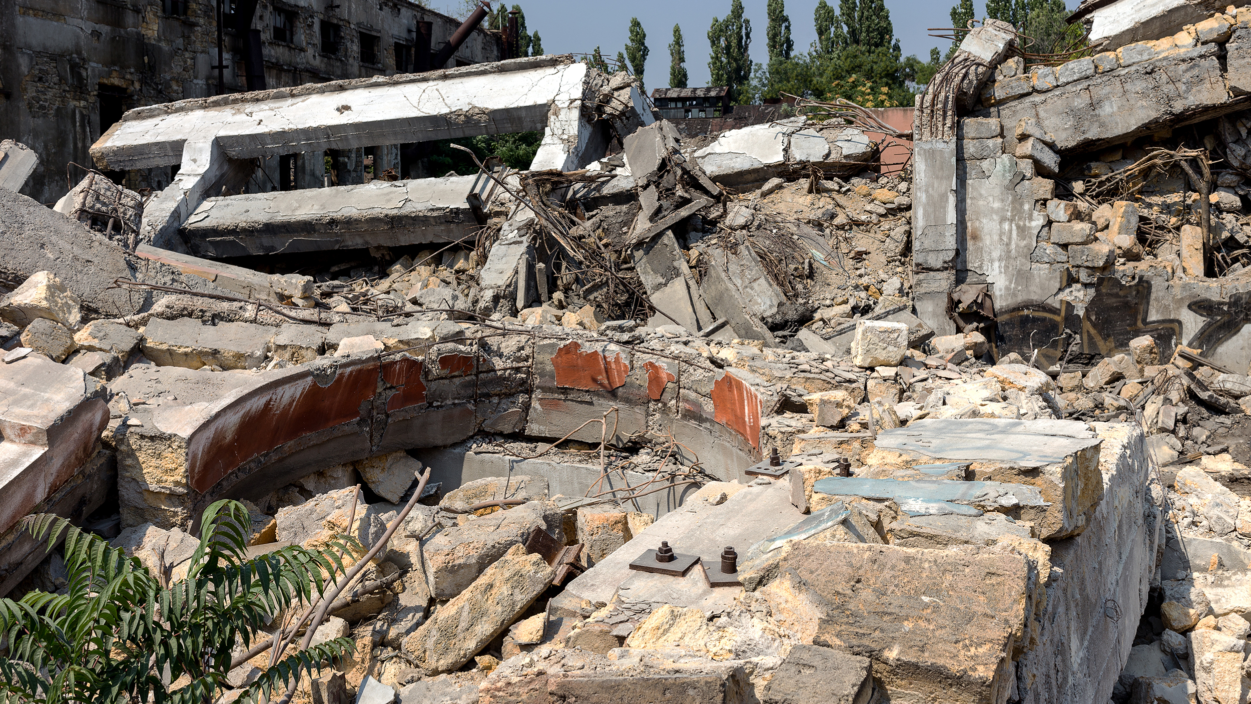 Landscape with the ruins of the old industrial factory buildings. The old industrial building after an earthquake.