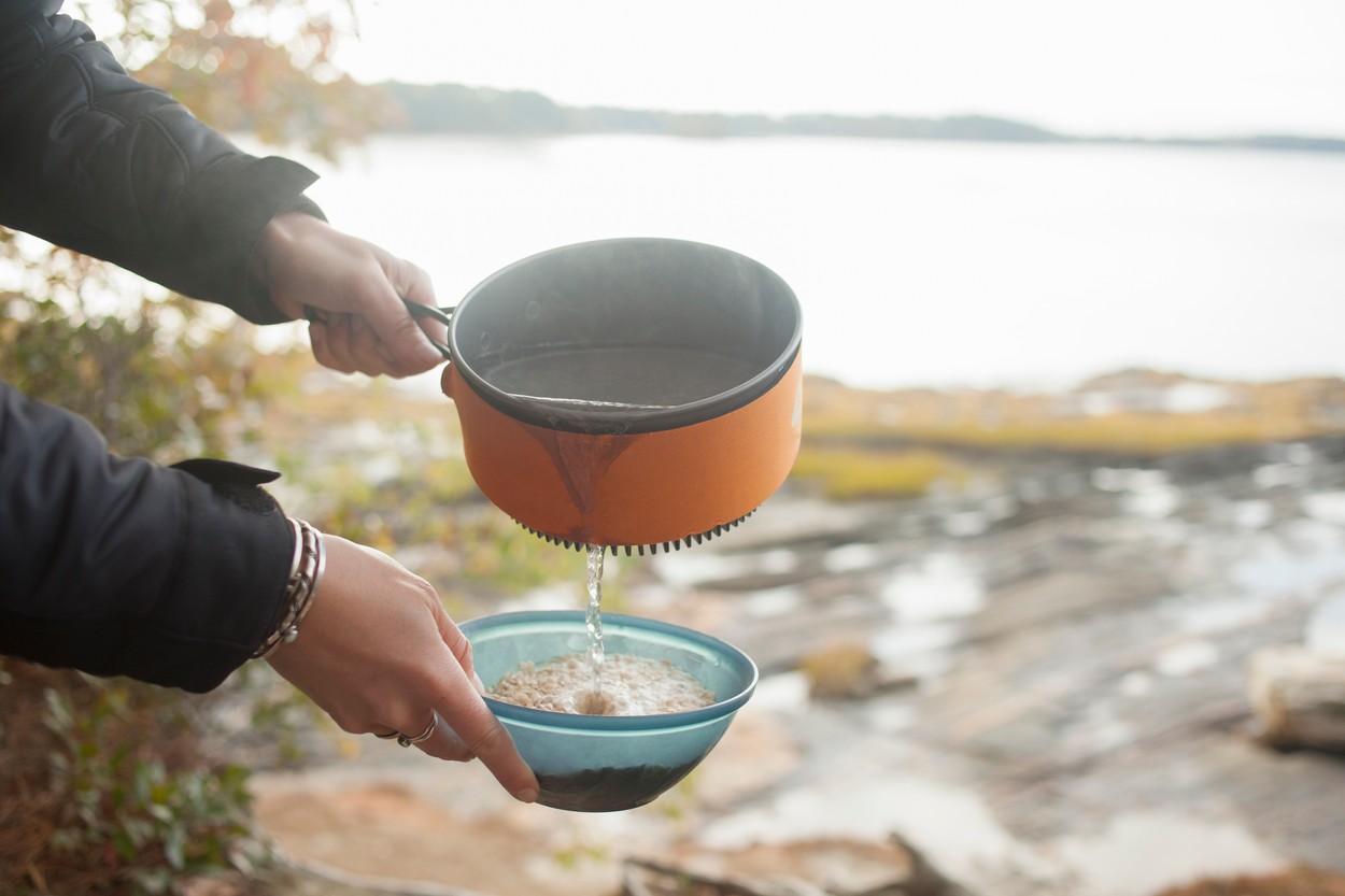 Preparing food at lakeside, Maine, USA
