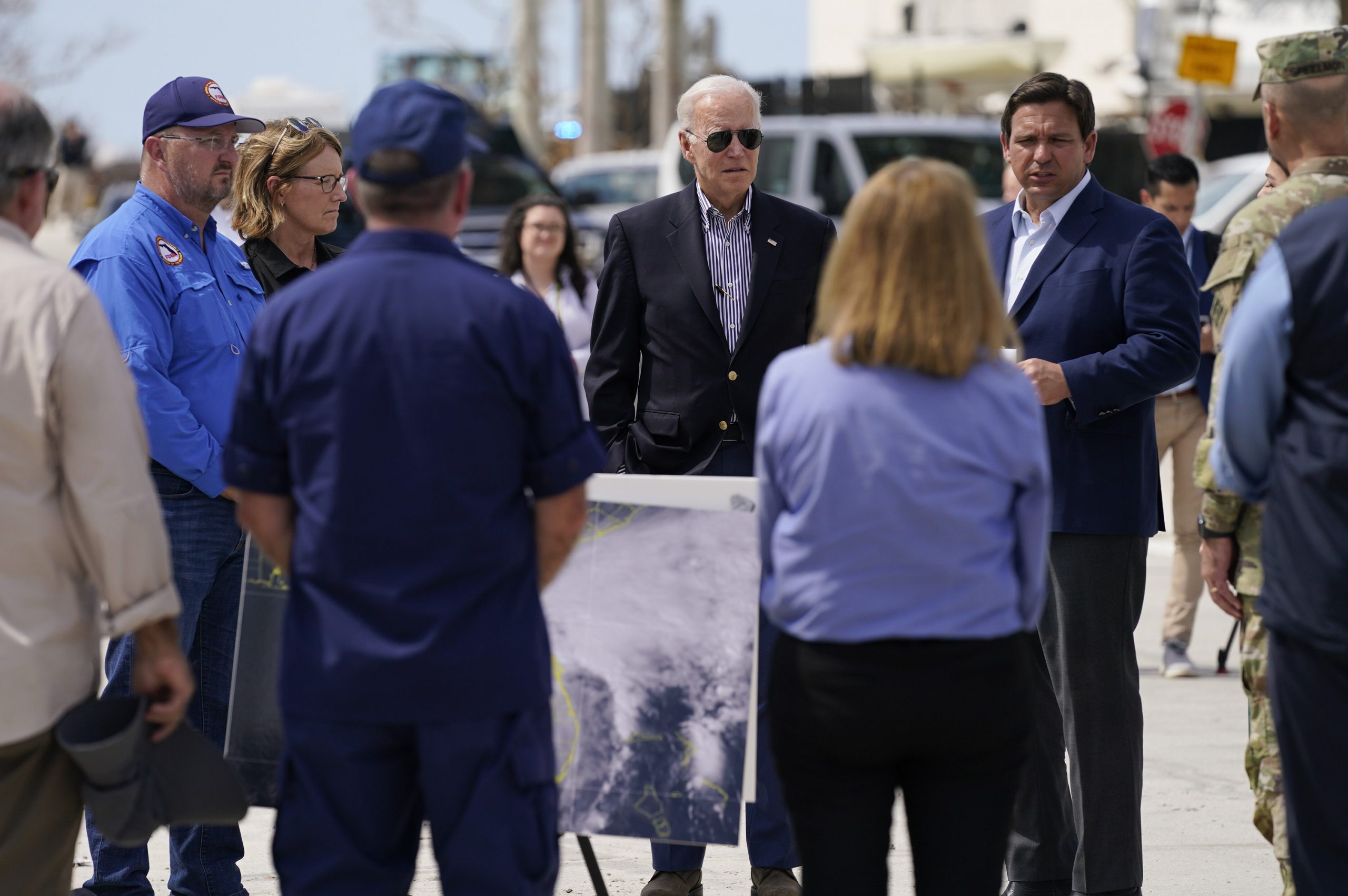 President Joe Biden listens as Florida Gov. Ron DeSantis, second from right, speaks during a briefing on response efforts to Hurricane Ian on Wednesday, Oct. 5, 2022, in Fort Myers Beach, Fla. (AP Photo/Evan Vucci)