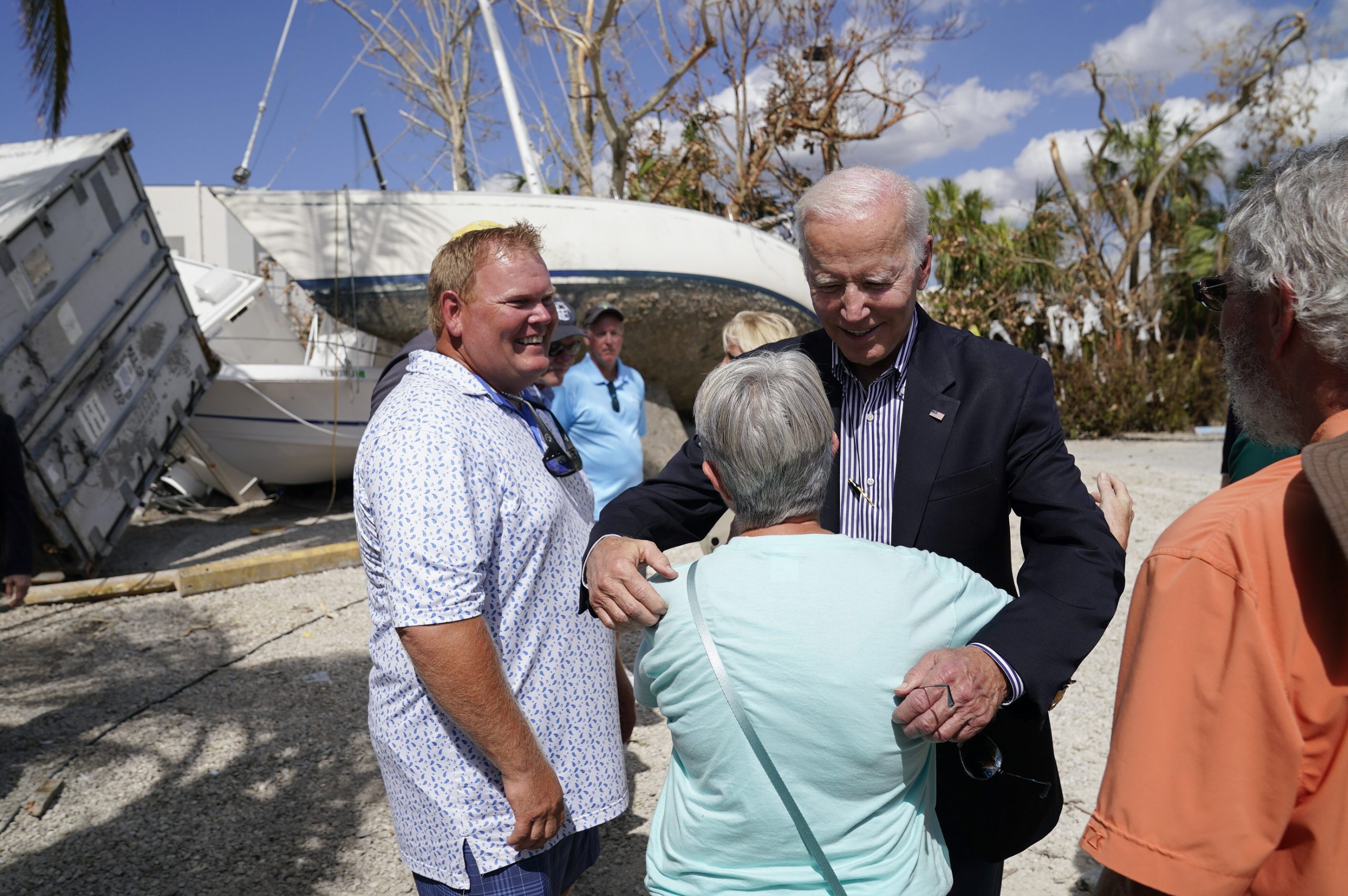 President Joe Biden hugs a person as he tours an area impacted by Hurricane Ian on Wednesday, Oct. 5, 2022, in Fort Myers Beach, Fla. (AP Photo/Evan Vucci)