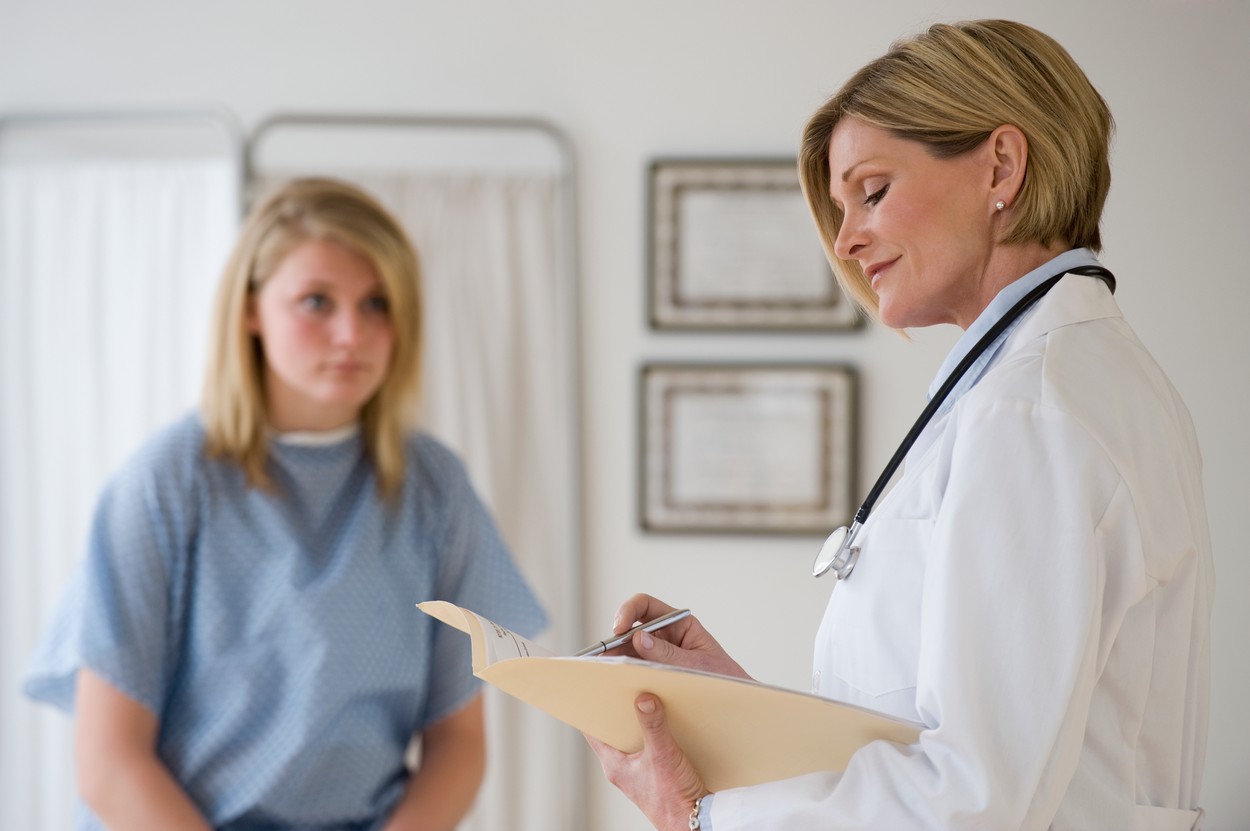 Female doctor reading chart