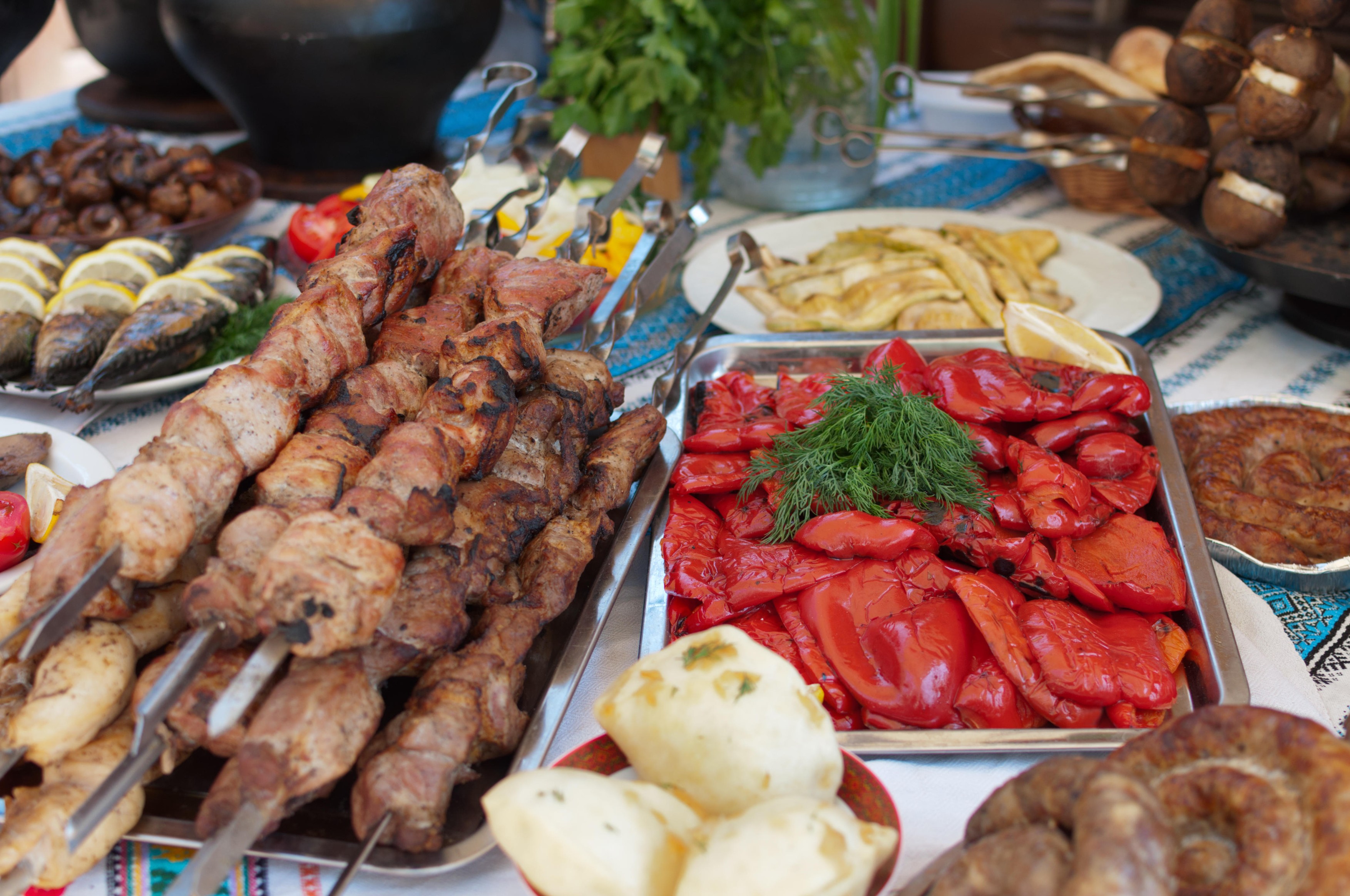 Meat and fish dishes with vegetables on table. Tablecloth with embroidery in the national Ukrainian style.,Image: 317060694, License: Royalty-free, Restrictions: , Model Release: no, Credit line: YAY Media AS / Alamy / Alamy / Profimedia