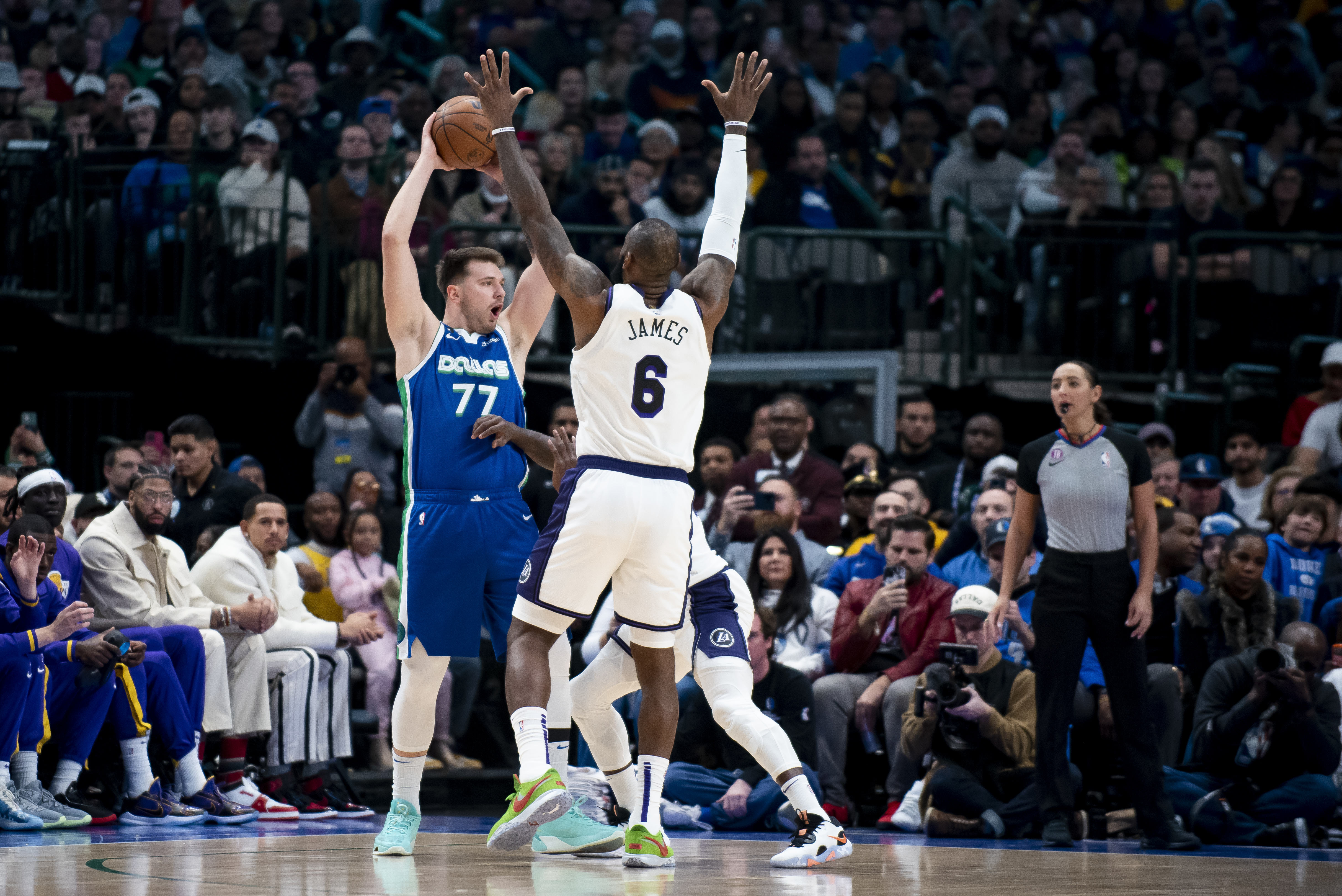 Dallas Mavericks guard Luka Doncic (77) attempts to pass the ball in the first half of an NBA basketball game in Dallas, Sunday, Dec. 25, 2022. (AP Photo/Emil T. Lippe)