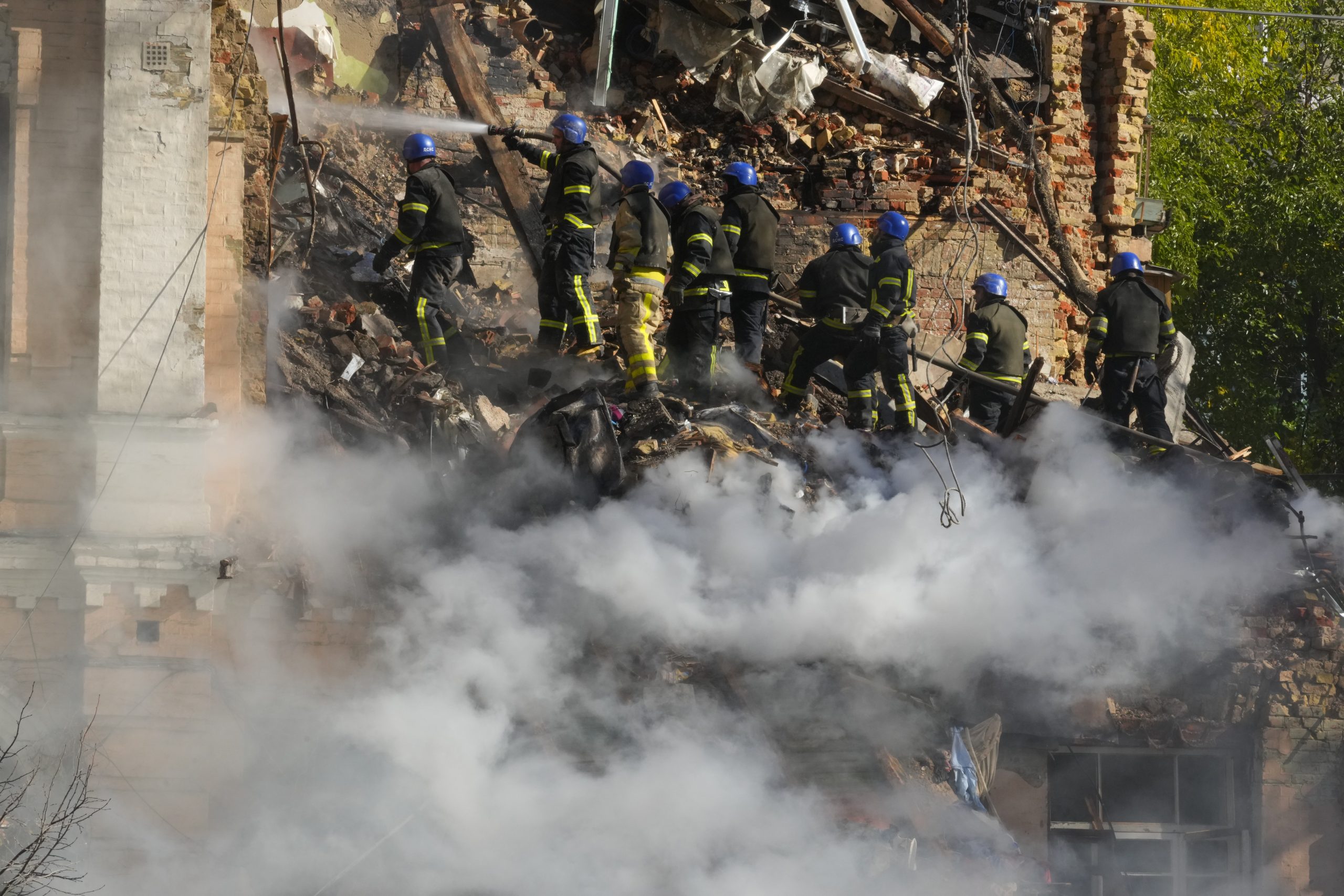 Firefighters try to extinguish a fire after a drone fired at buildings in Kyiv, Ukraine, Monday, Oct. 17, 2022. (AP Photo/Efrem Lukatsky)