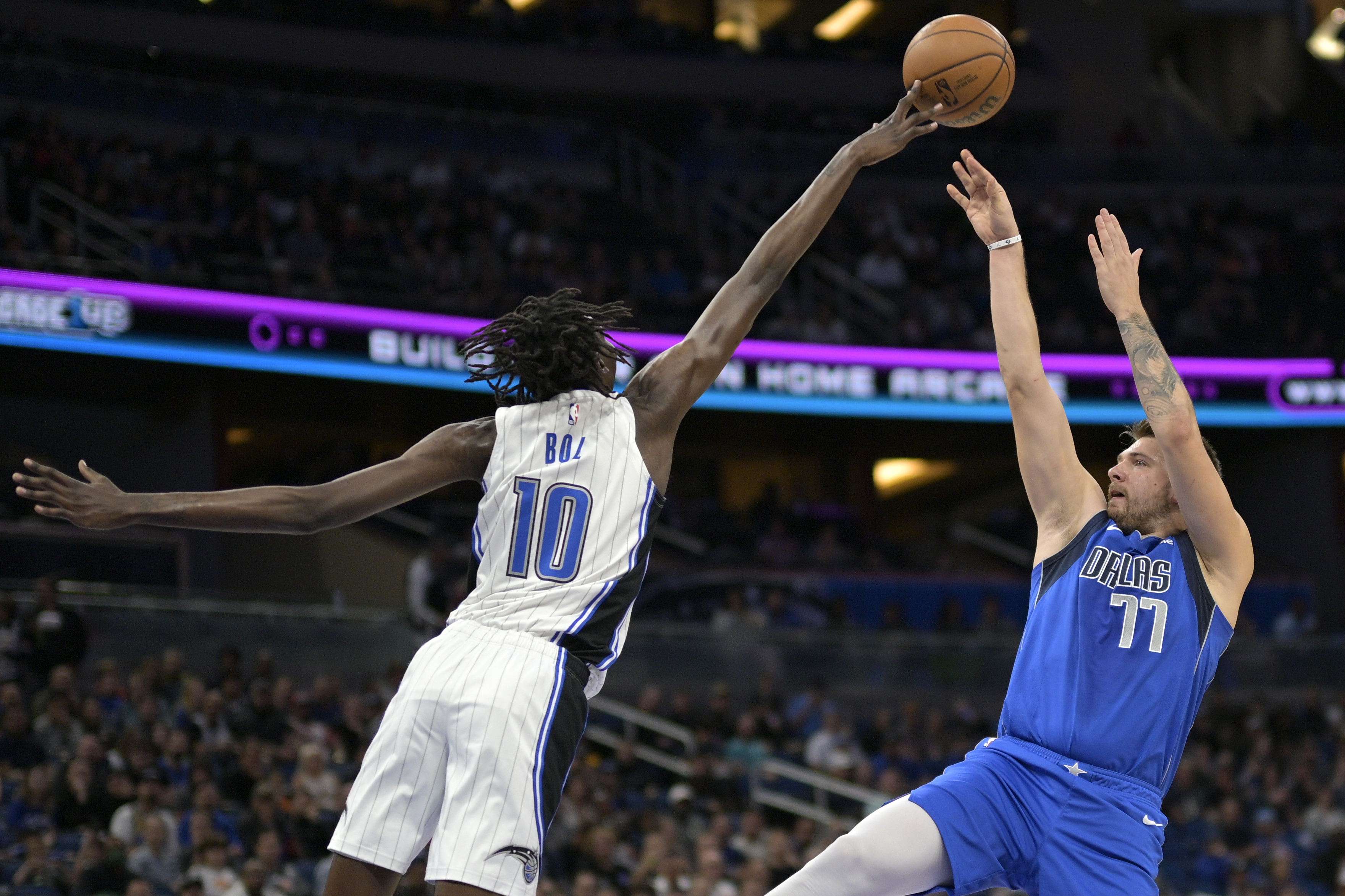 Orlando Magic center Bol Bol (10) blocks a shot by Dallas Mavericks guard Luka Doncic (77) during the first half of an NBA basketball game, Wednesday, Nov. 9, 2022, in Orlando, Fla. (AP Photo/Phelan M. Ebenhack)