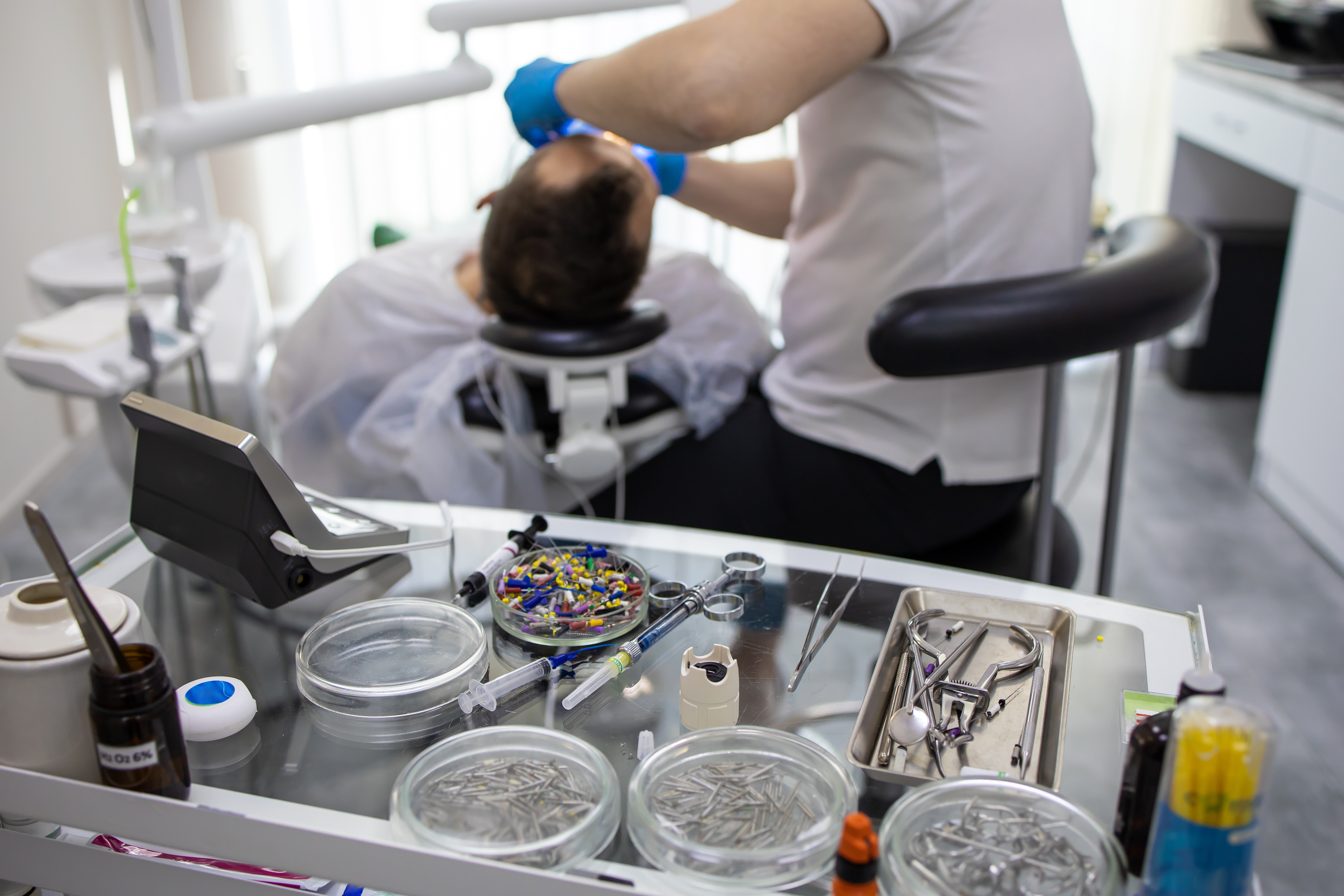 Practitioner,Male,Dentist,Drilling,Tooth,To,Patient,In,Dental,Studio