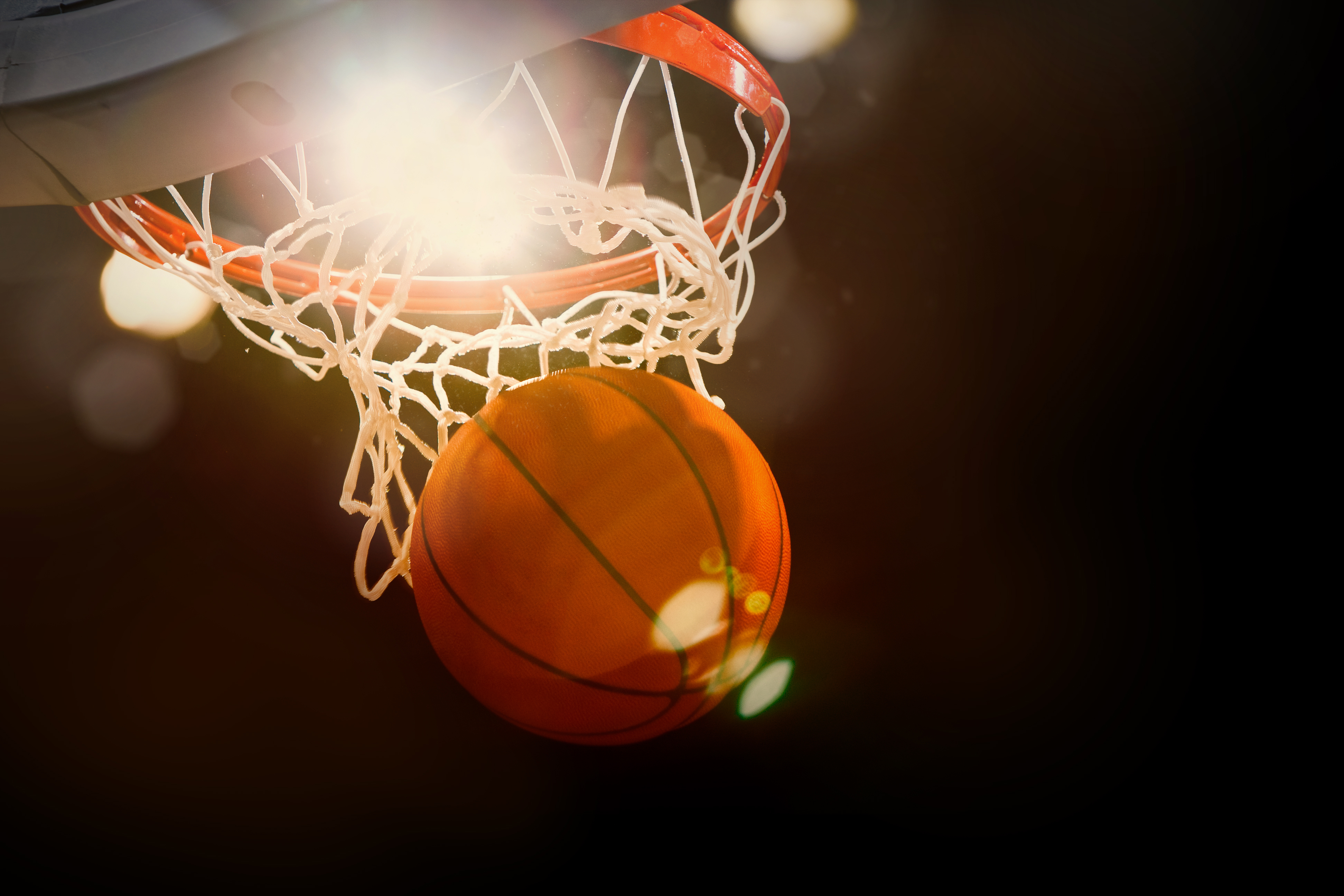 Basketball,Going,Through,The,Basket,At,A,Sports,Arena,(intentional