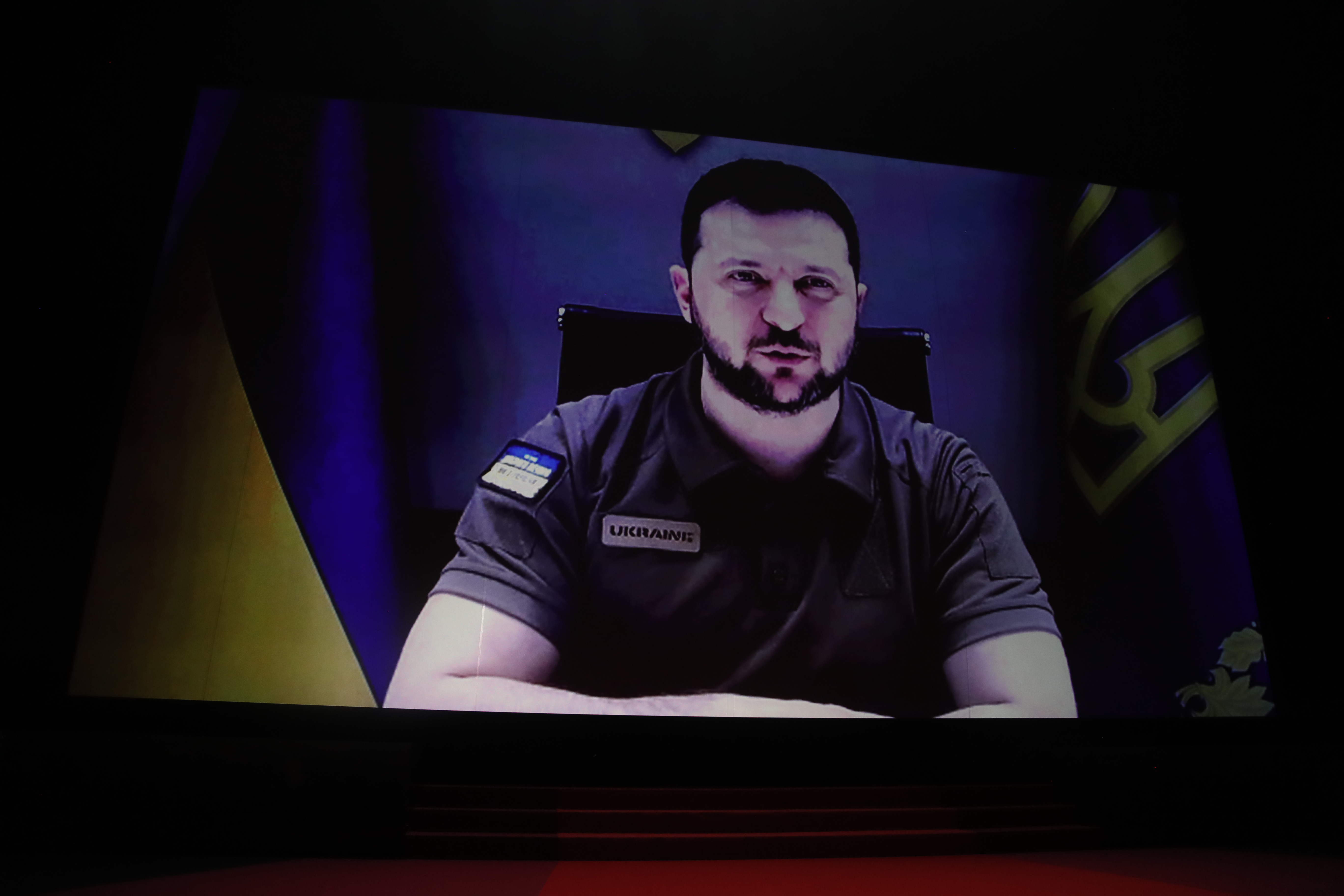 epa09953432 Ukraine's President Volodymyr Zelensky appears via remote on a screen during the Opening Ceremony of the 75th annual Cannes Film Festival, in Cannes, France, 17 May 2022. The festival runs from 17 to 28 May.  EPA-EFE/GUILLAUME HORCAJUELO