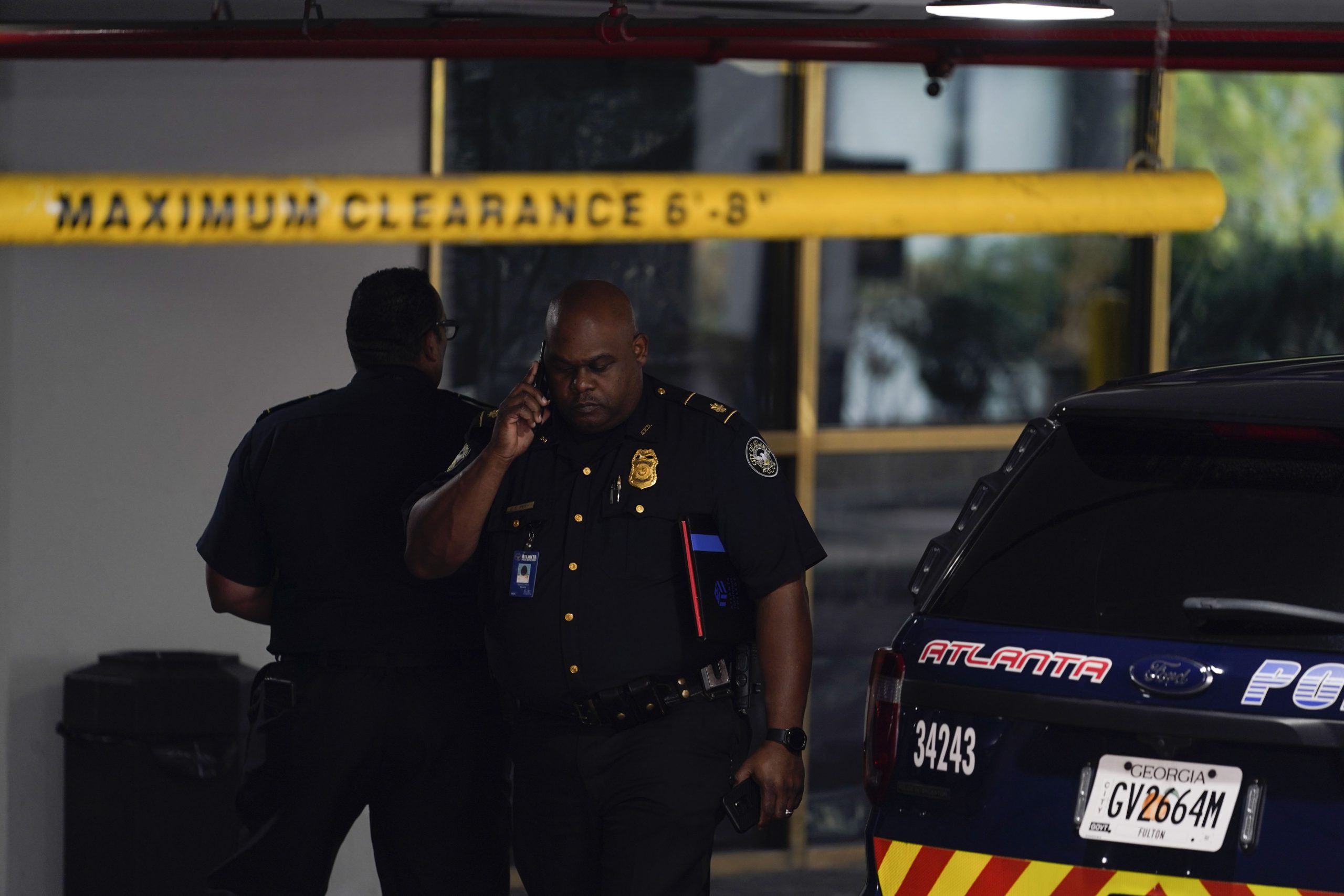 A police officer is seen on scene where a shooting occurred, Monday, Aug. 22, 2022, at a condominium in Atlanta. (AP Photo/Brynn Anderson)