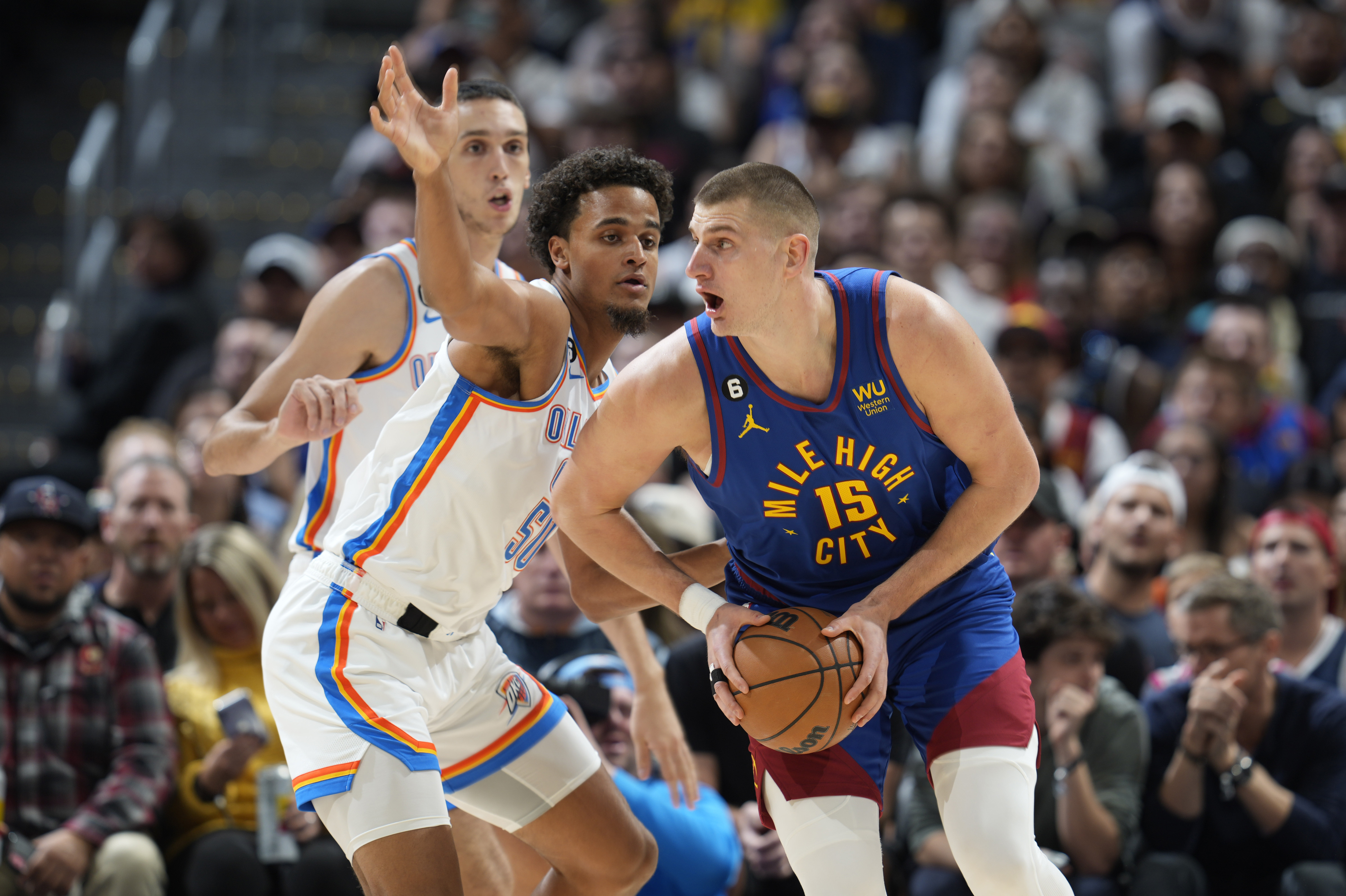 Denver Nuggets center Nikola Jokic, right, drives past Oklahoma City Thunder forwards Jeremiah Robinson-Earl, front left, and Aleksej Pokusevski in the first half of an NBA basketball game Saturday, Oct. 22, 2022, in Denver. (AP Photo/David Zalubowski)
