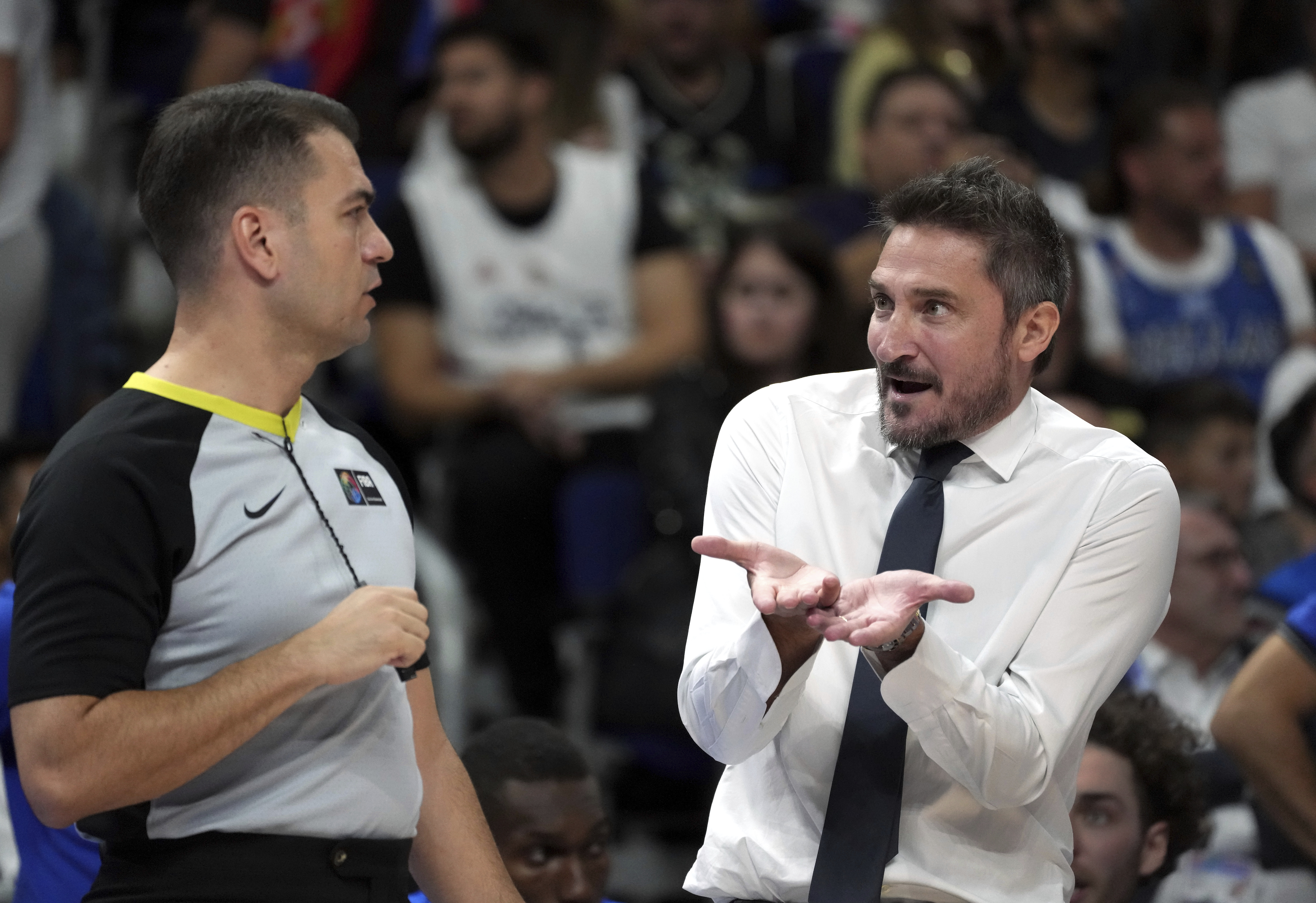 Italy's head coach Gianmarco Pozzecco, right, gestures towards a referee the Eurobasket round of sixteen basketball match between Serbia and Italy in Berlin, Germany, Sunday, Sept. 11, 2022. (AP Photo/Michael Sohn)