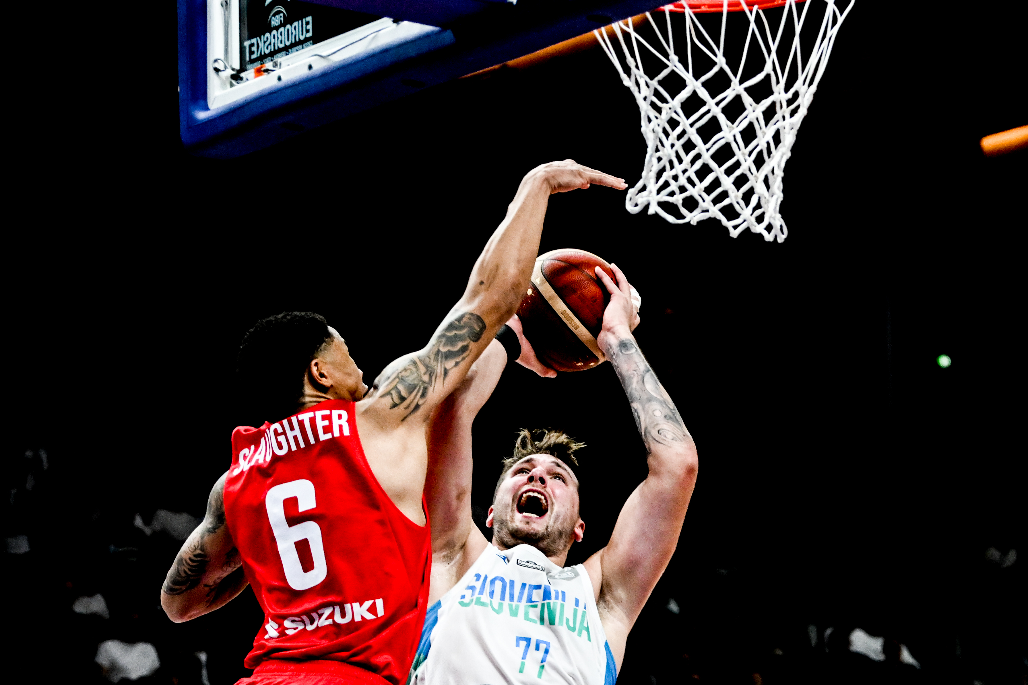 epa10184617 A.J. Slaughter (L) of Polandin action against Luka Doncic of Slovenia during the FIBA EuroBasket 2022 Quarter Finals match between Slovenia and Poland at EuroBasket Arena in Berlin, Germany, 14 September 2022.  EPA-EFE/FILIP SINGER