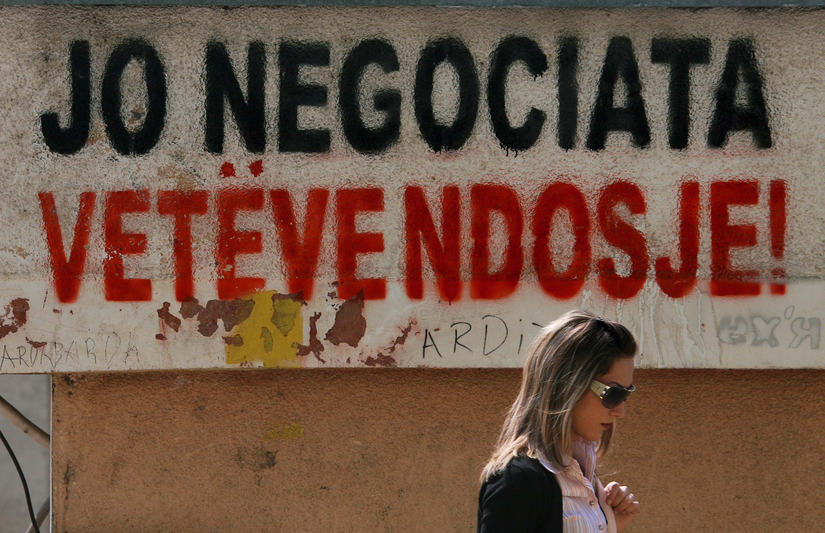 samoopredeljenje kosovo An ethnic Albanian woman walks past a graffiti reading: "No negotiation - Self-determination"