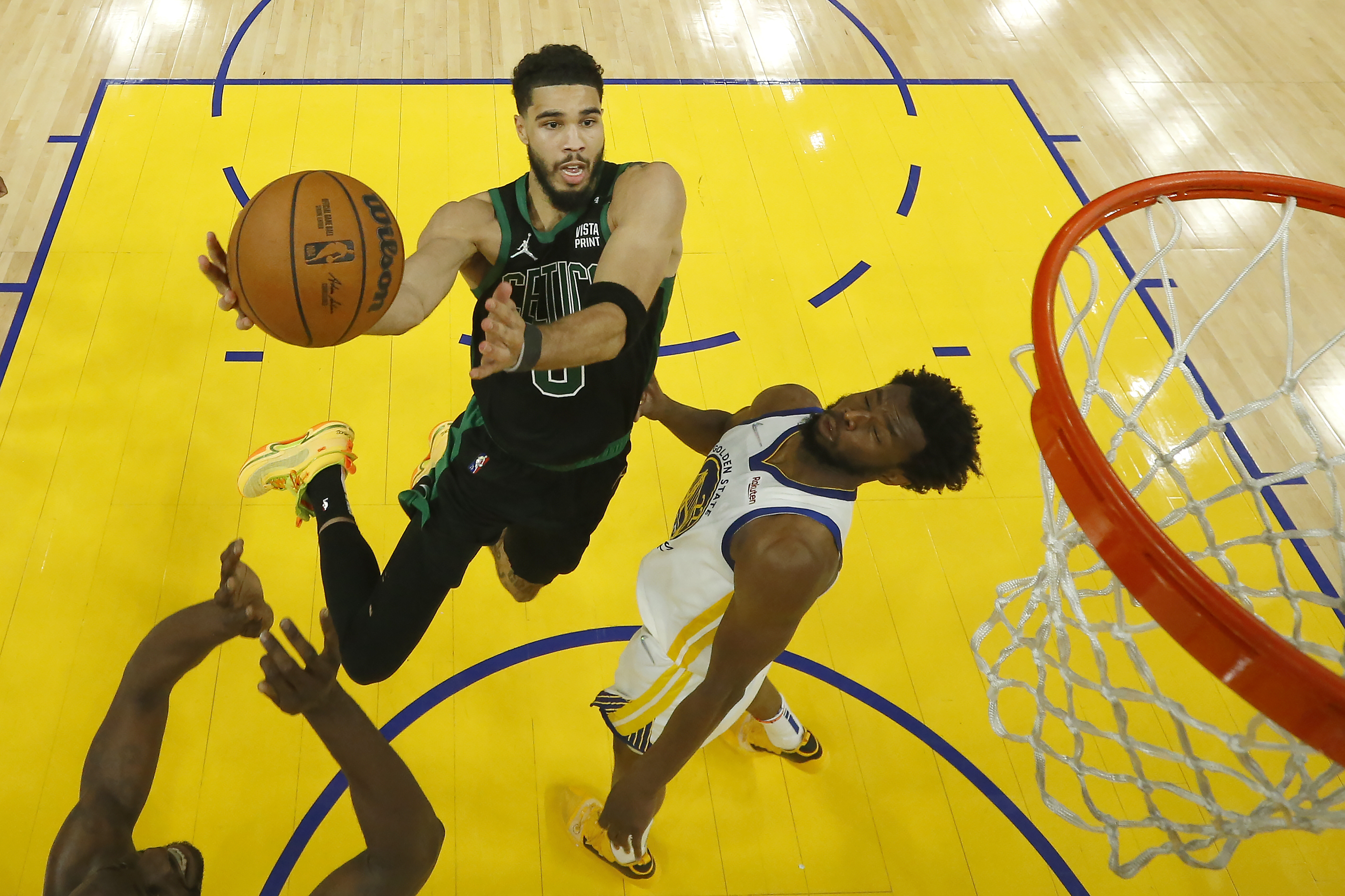 Boston Celtics forward Jayson Tatum, left, shoots against Golden State Warriors forward Andrew Wiggins during the second half of Game 5 of basketball's NBA Finals in San Francisco, Monday, June 13, 2022. (AP Photo/Jed Jacobsohn, Pool)